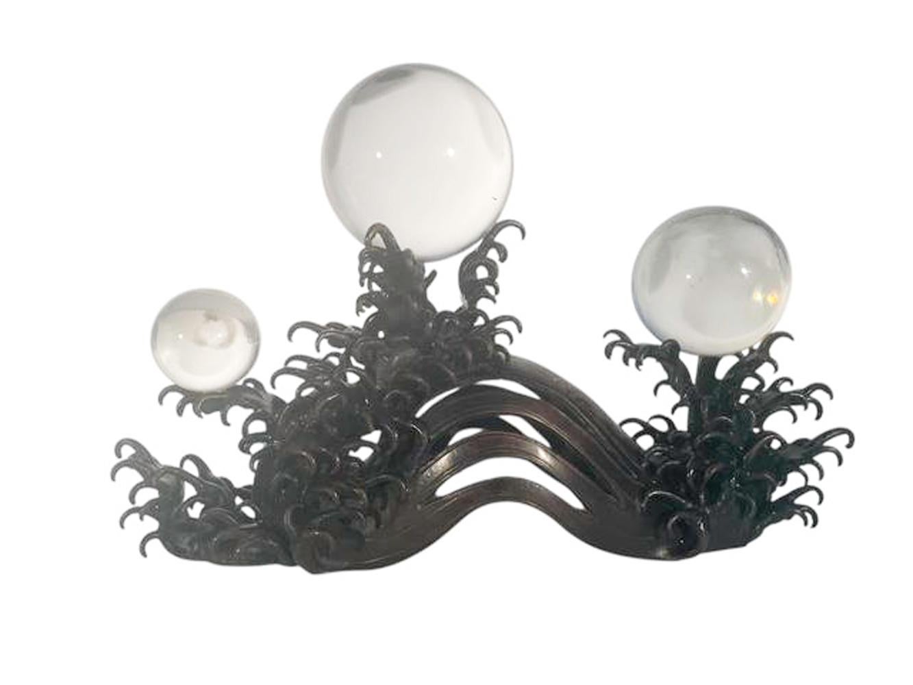 Japanese Meiji period bronze and crystal sculpture (okimono) of stylized waves supporting three crystal balls of varying size. Signed on underside.