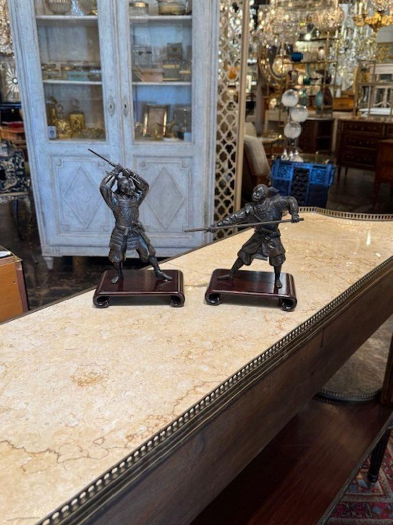 Pair of 19th century Japanese bronze fighting Samurai warriors on stands. Circa 1880. A timeless and classic touch for a fine interior. 10H x 6W x 4D