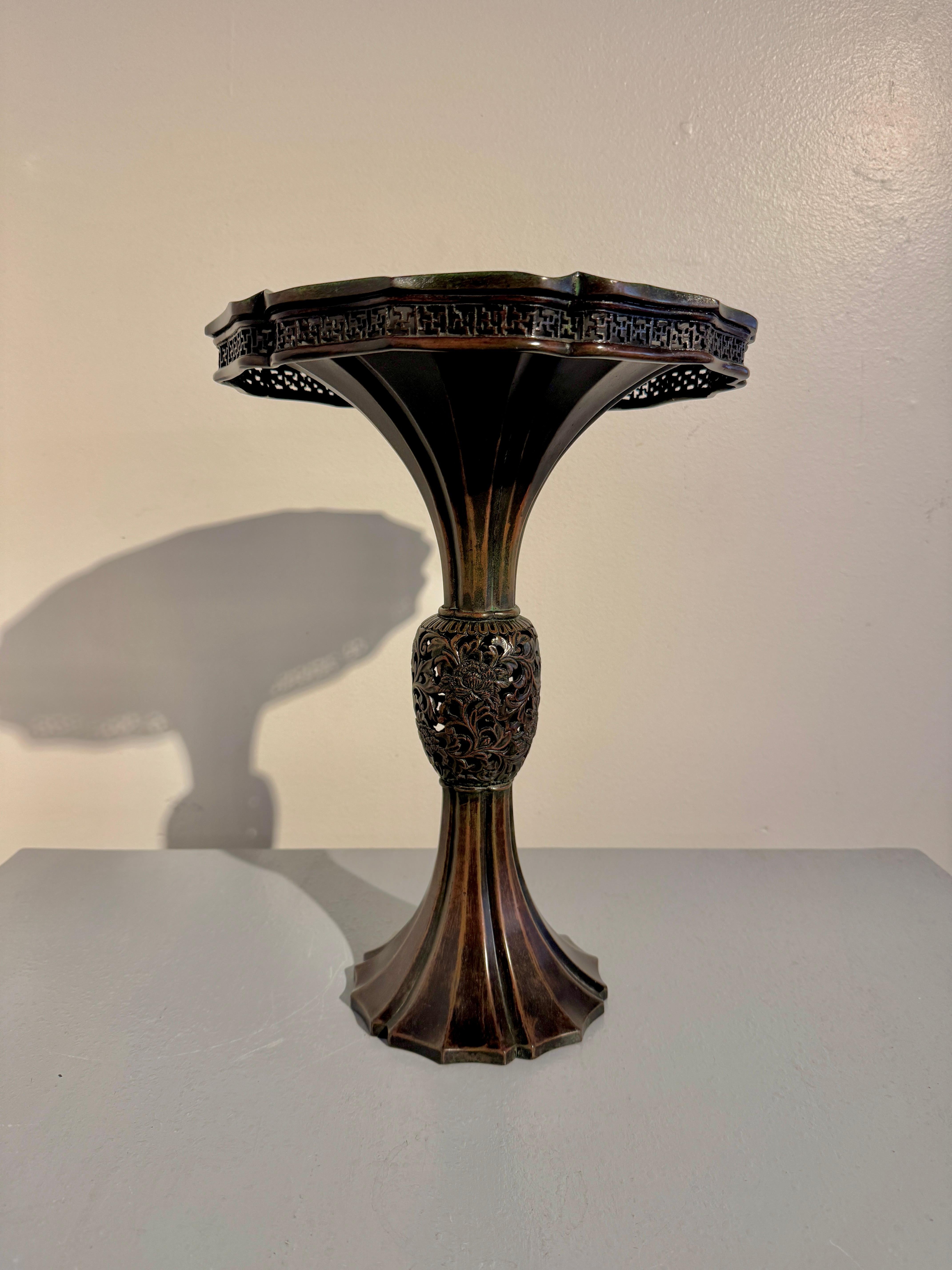A striking Japanese cast and carved patinated bronze trumpet mouth vase for flower displays, Edo to Meiji Period, mid 19th century, circa 1860, Japan.

The tall and elegant bronze flower vase of 