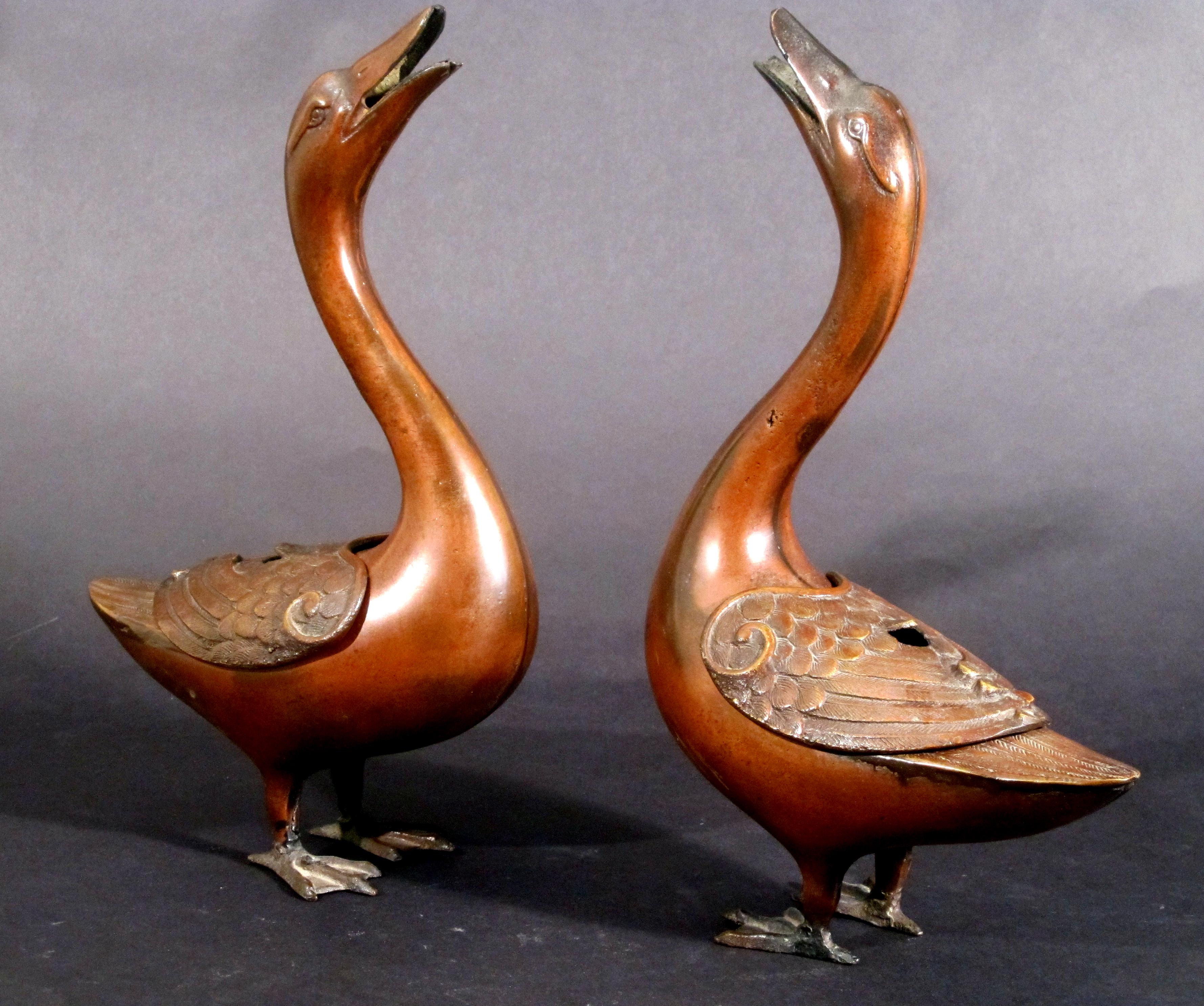 Japanese bronze geese koros, 
Late 19th century.

The pair of goose koros or censors are in the form of geese with their long necks extended and their heads tipped up and their hollow mouths open. They are free-standing with large web feet. The
