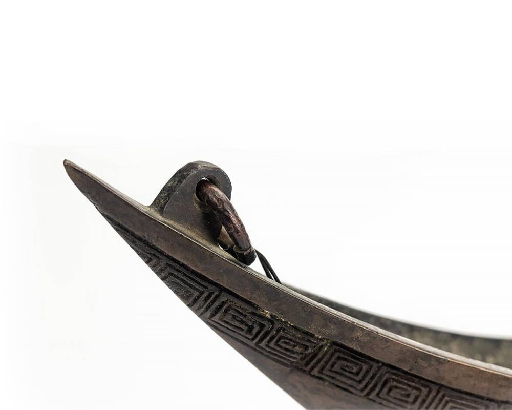 Something to enhance your alfresco dining on a still, warm summer evening, an unusual Japanese bronze hanging ikebana container in the shape of a boat. This handsome piece is beautifully finished with a fine mottled patina and is strong enough to