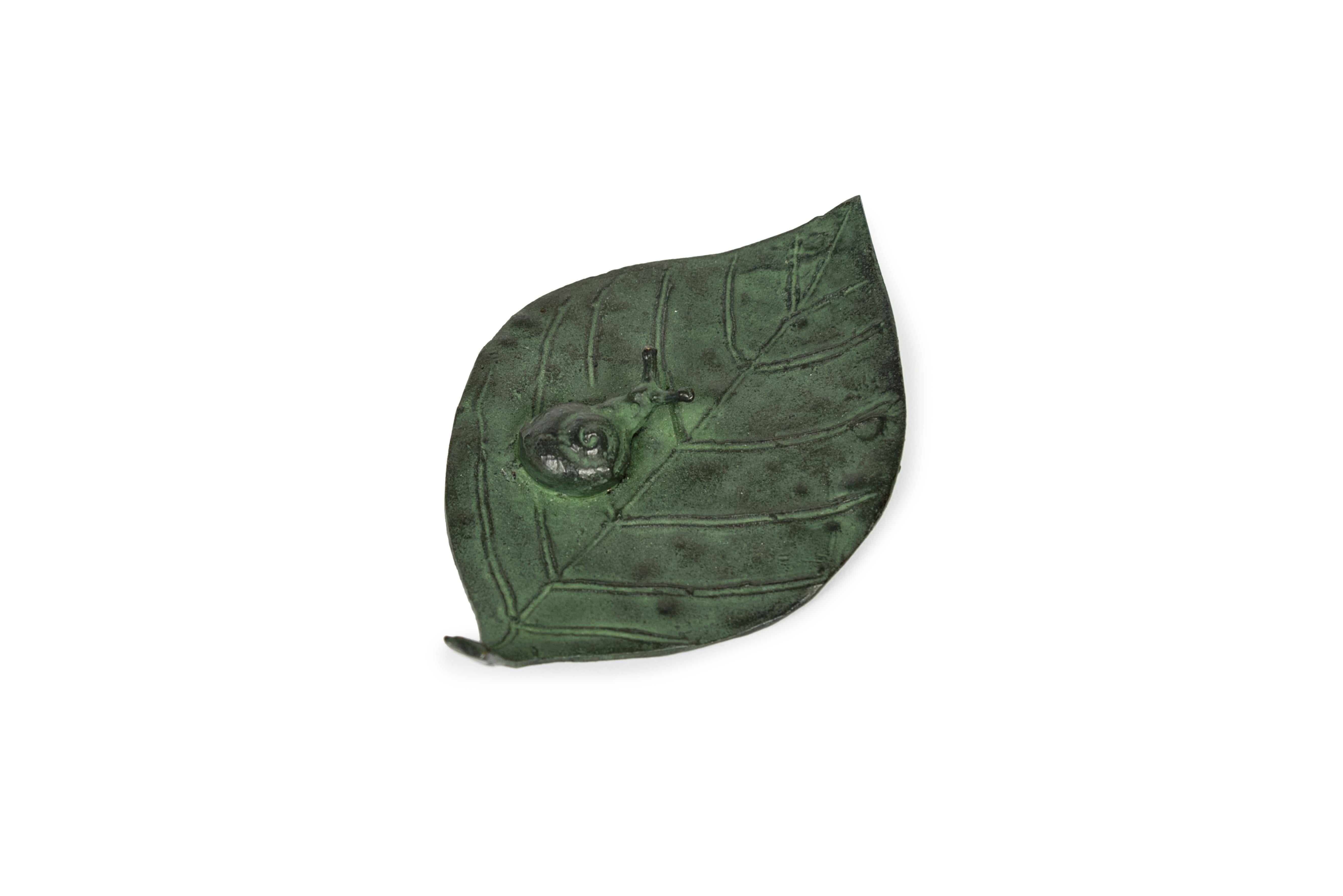 Petit plateau en bronze à patine verte en forme de feuille avec un escargot dessus. 
Signature sous 