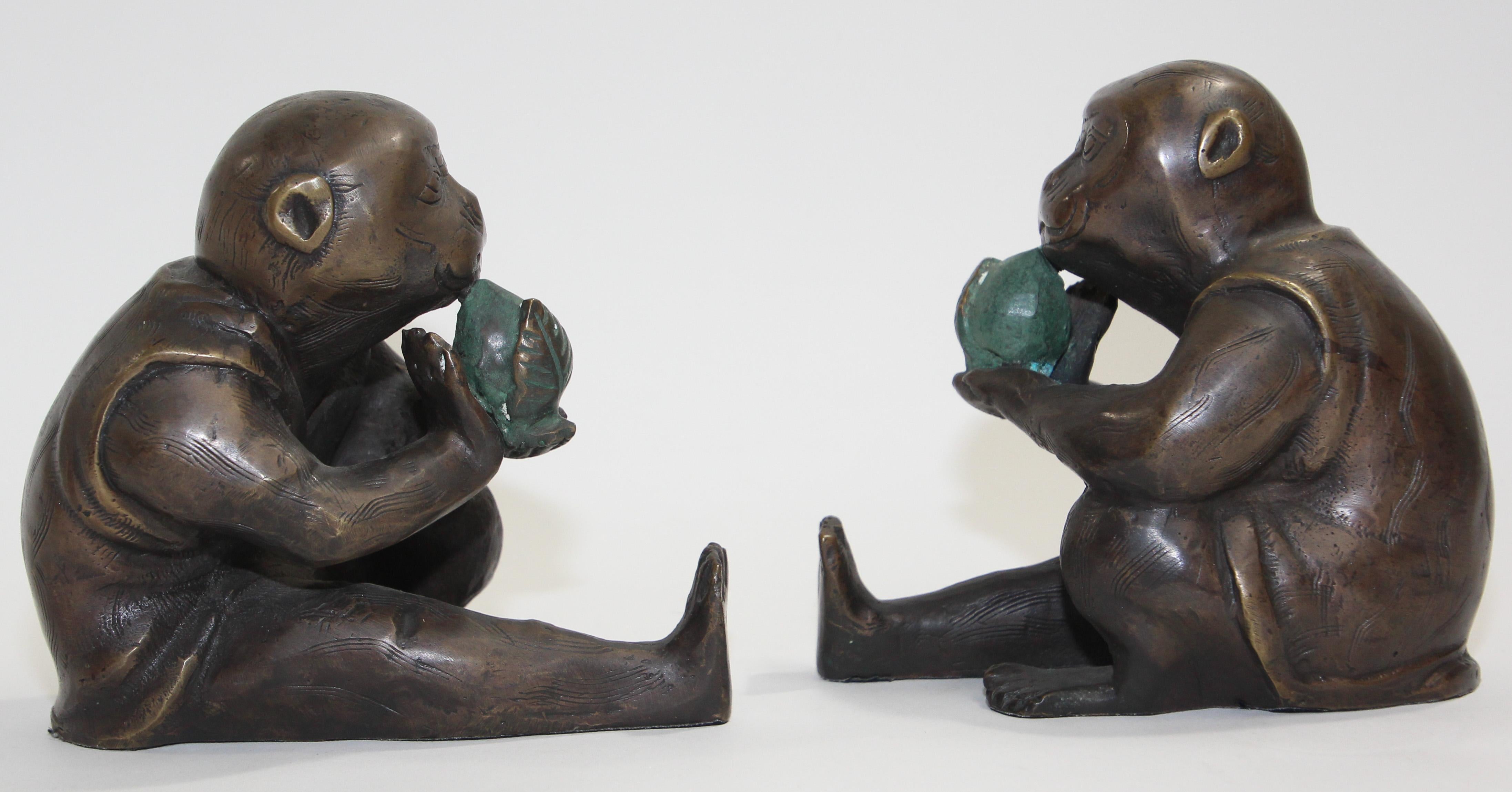 Japanese Monkey Okimono cast bronze Sculptures
A pair of Okimono Meiji style bronze figure of a monkey wearing a kimono holding a peach.
Seated upright the monkey stares with wide open eyes and a slightly perplexed expression holding a peach in