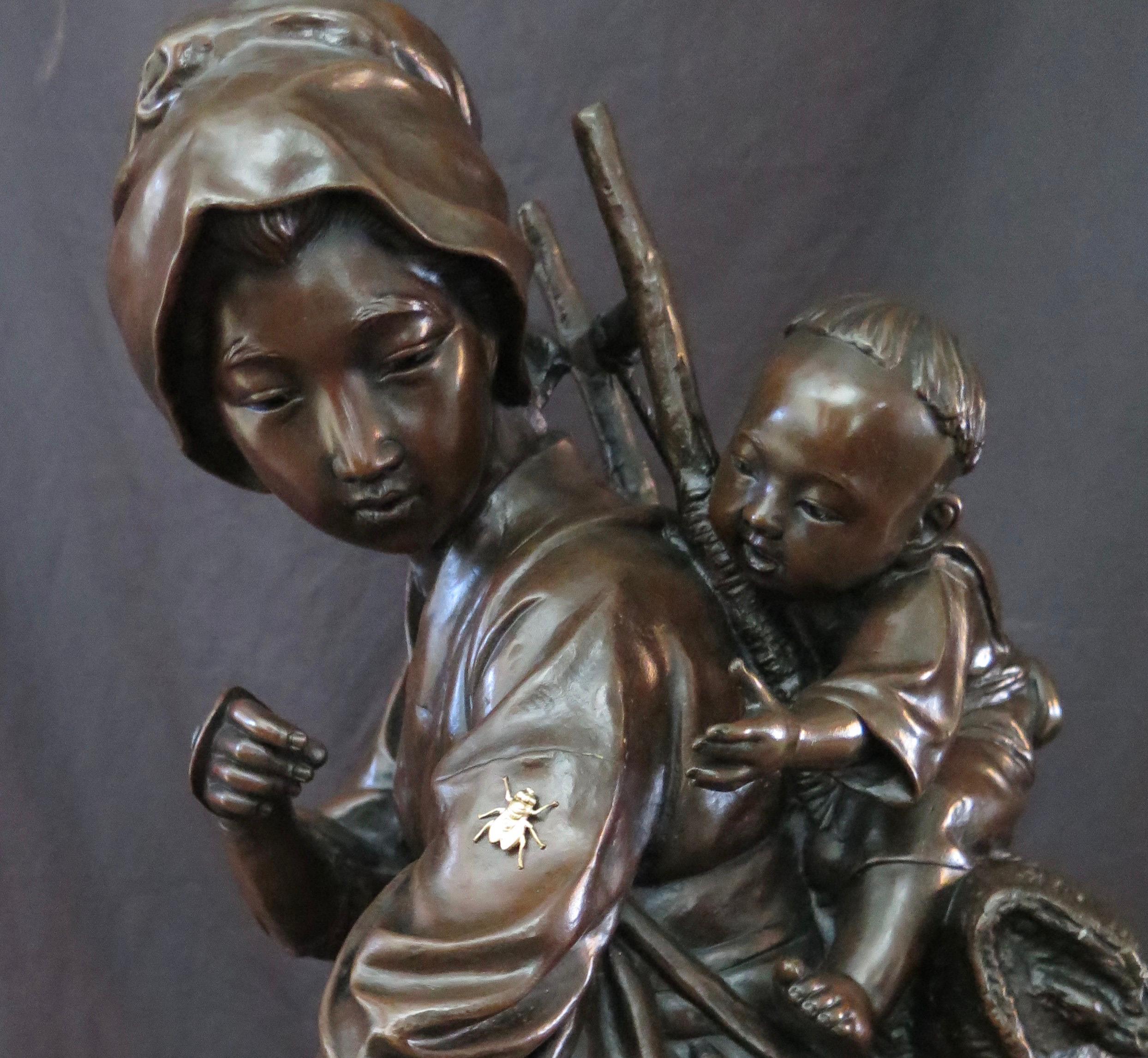 This vintage 19th century signed Japanese bronze sculpture dates from the Meiji period. This incredibly detailed work of art highlights a tender moment between a mother & her child sharing the discovery of a stray insect on mother's sleeve. The use