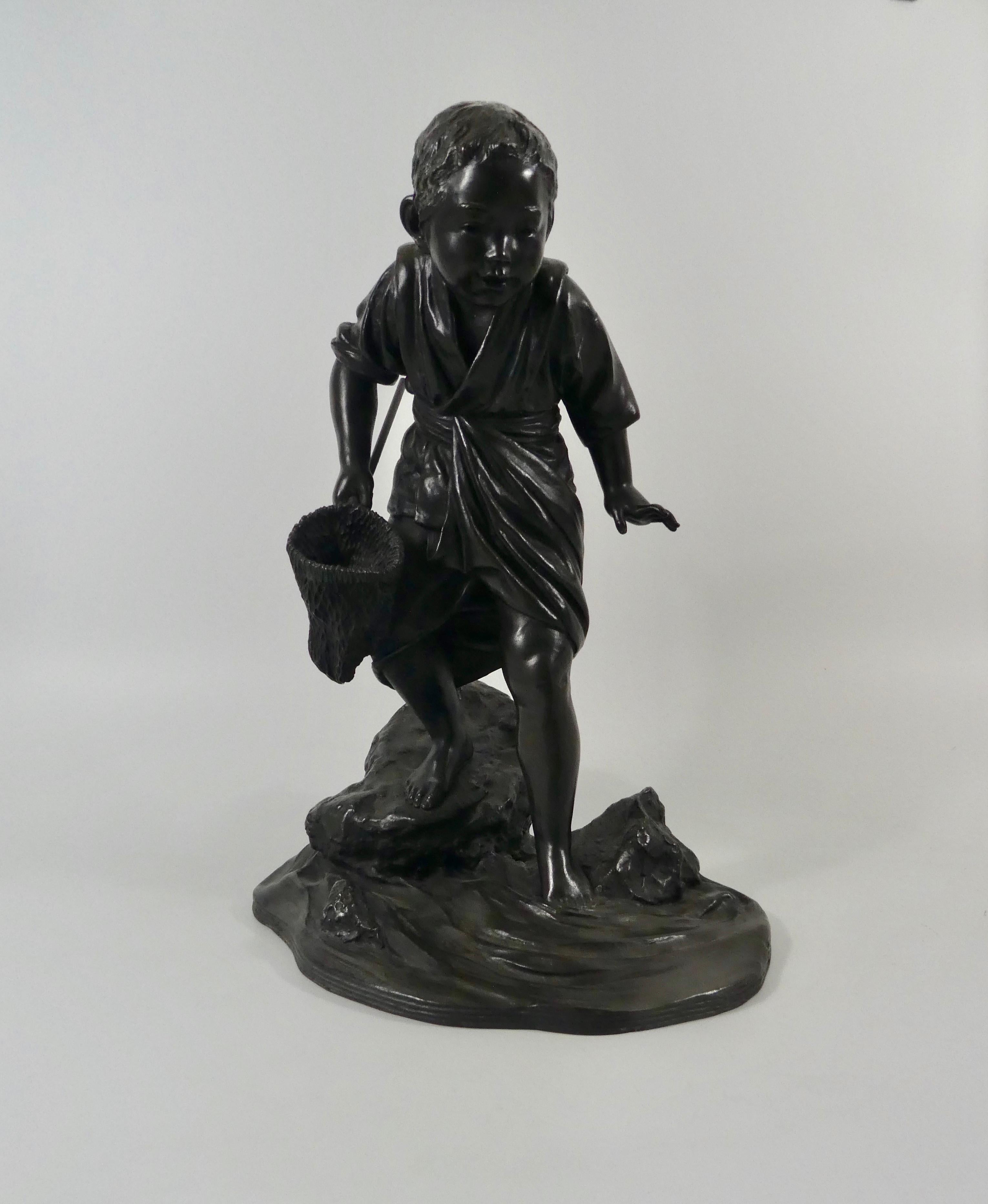 A fine Japanese bronze okimono, circa 1890, Meiji period. Cast as a young boy, carrying fishing net, and carefully making his way barefooted over rocks, in a river. He wears a short tunic, tied at the waist, with the fishing net in his right