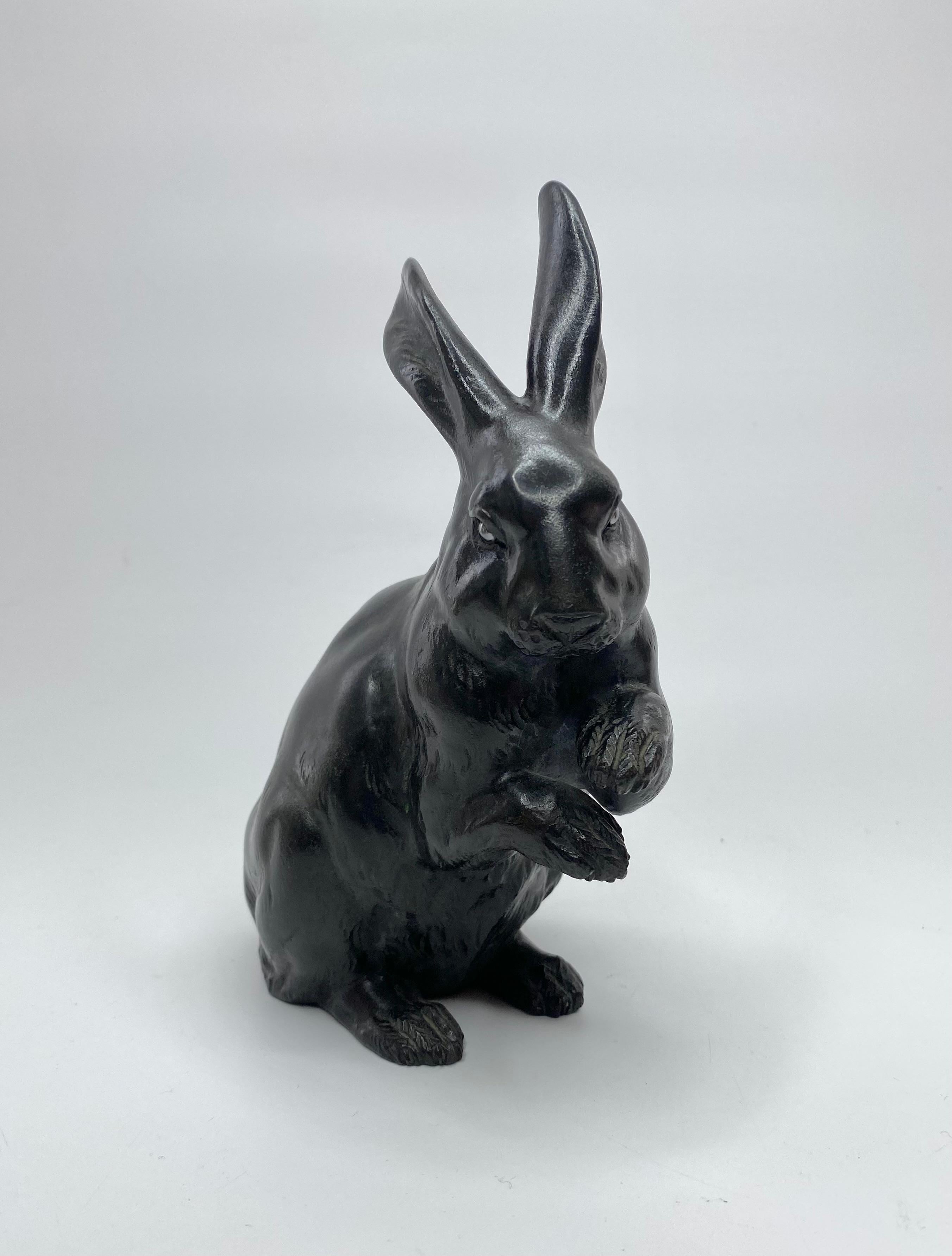 Japanese bronze okimono of a rabbit, Maruki Company, Meiji Period. This charming study, cast as a seated rabbit, with its ears erect, and a curious expression on its face.
Having shakudo inlaid eyes.
Maruki Company seal mark to the base.
Height –