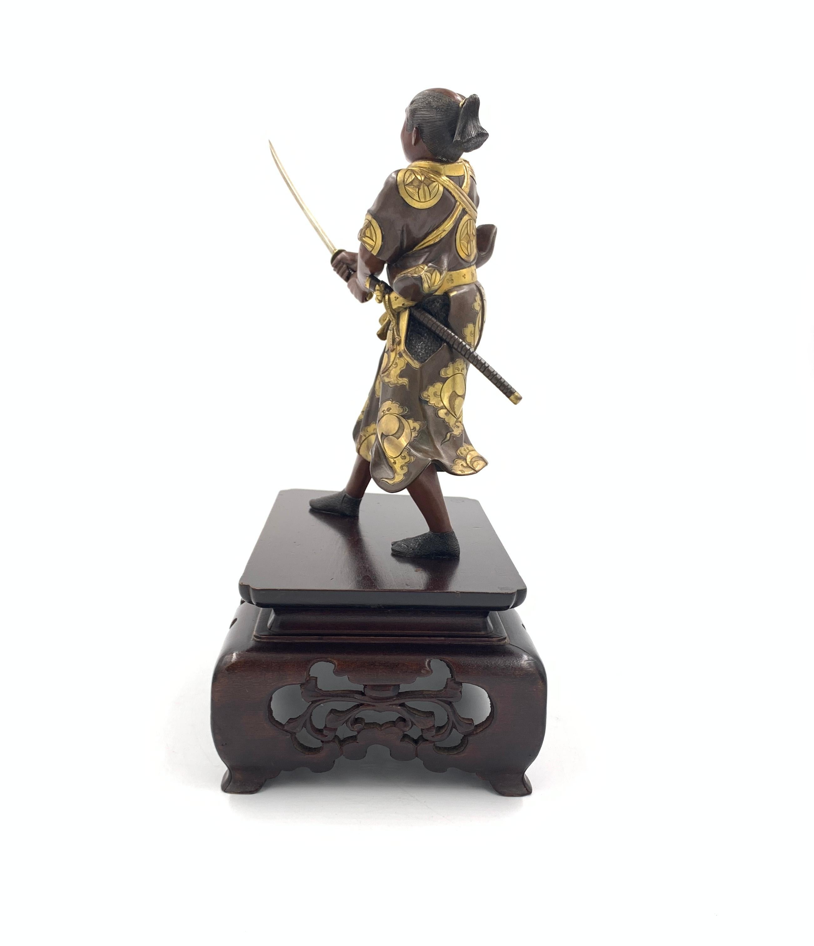 A fine signed Japanese bronze Samurai warrior advancing with a katana, wearing a richly decorated ornate robe, Meiji Period.
   