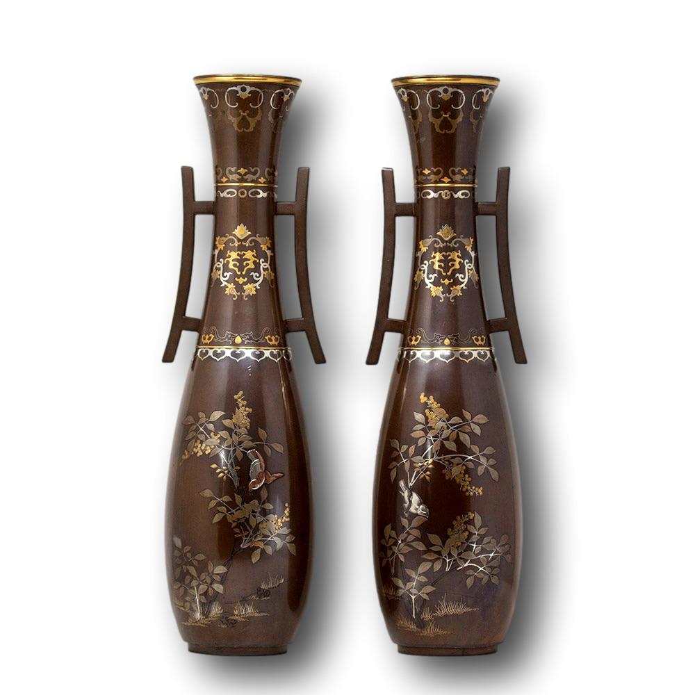 A fine large sized pair of Japanese bronze vases. The vases each surmounted by waisted necks flanked by two spreading handles with accents in the form of Japanese Torri (traditional Japanese gates) above a bulbous body upon a spreading circular