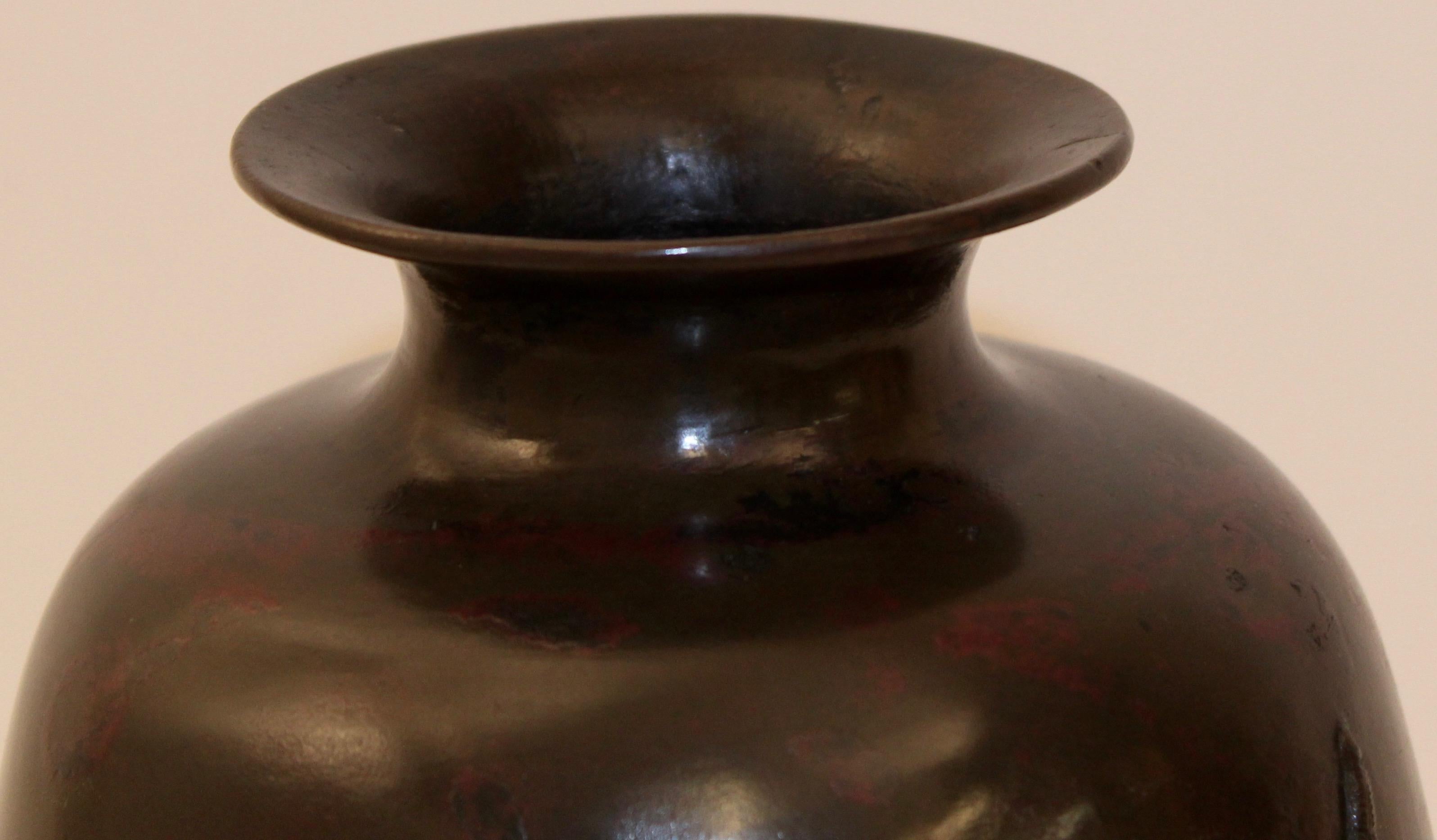 Japanese 19th century bronze vase with applied bronze tortoises. The outwardly tapering vase, features three finely cast applied bronze tortoises and relief strokes.