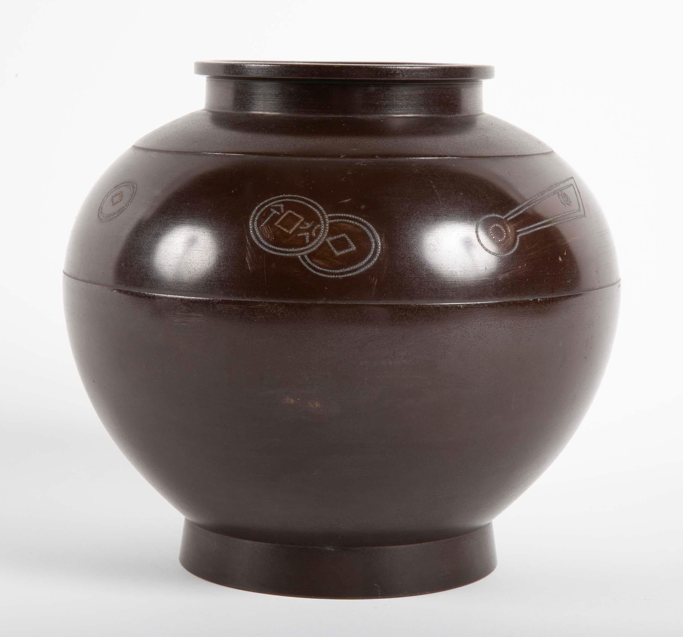 Japanese Bronze Vase with Silver Coin Inlay having bulbous body with close neck and rim.   Early 20th century.