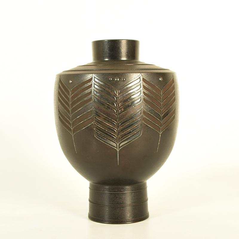 If you have a penchant for styling reminiscent of Art Deco, then we have just the thing to satisfy your desire. This fabulous Japanese bronze vase is elegantly stamped in a formal design, one element of which has been tastefully accented with silver