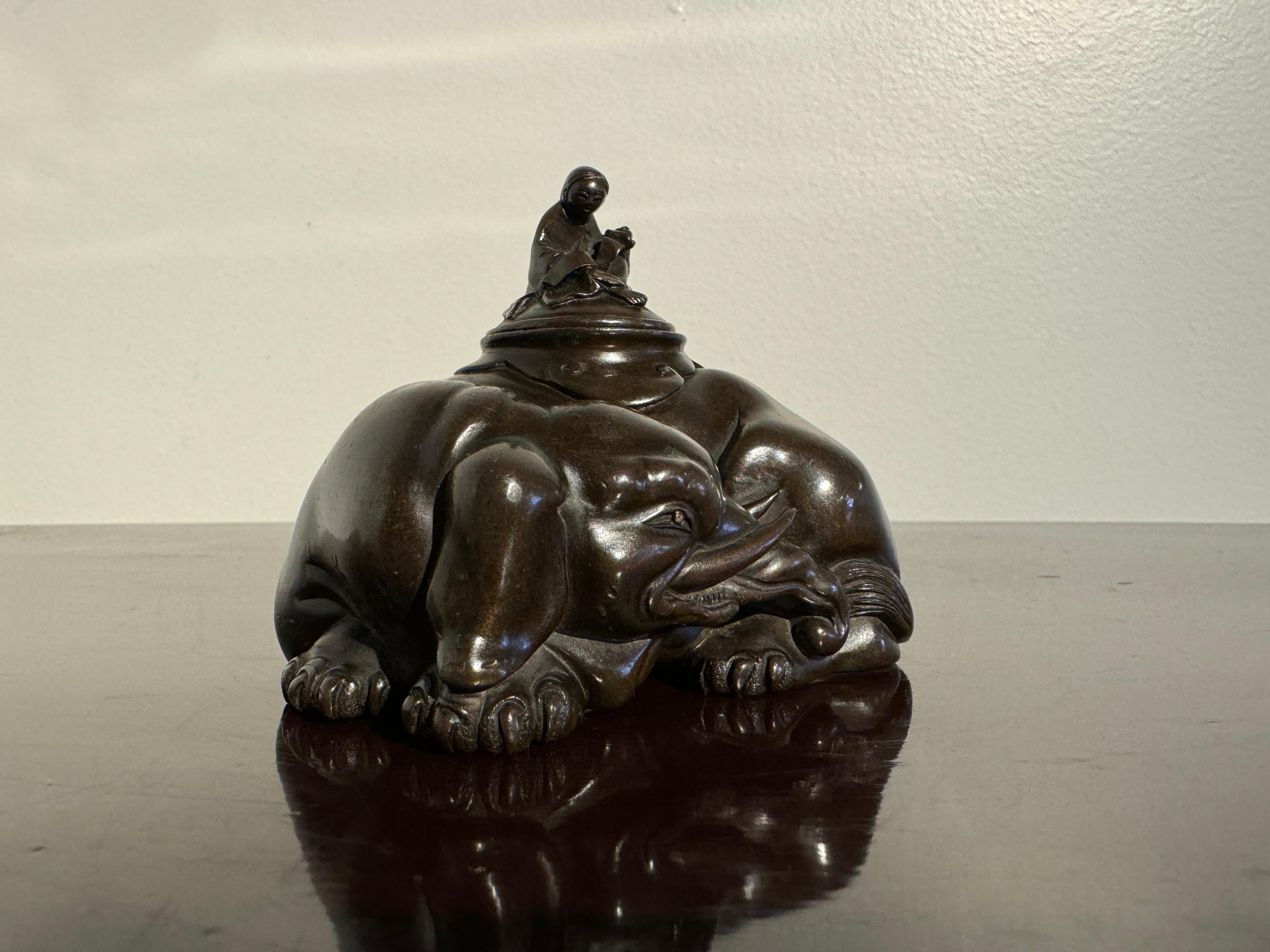 A very finely cast Japanese bronze water coupe in the form of the courtesan Eguchi riding an elephant, signed Kazutada, Edo to Meiji Period, mid 19th century, Japan.

The small and elegant bronze water coupe is exquisitely cast to depict a figure of