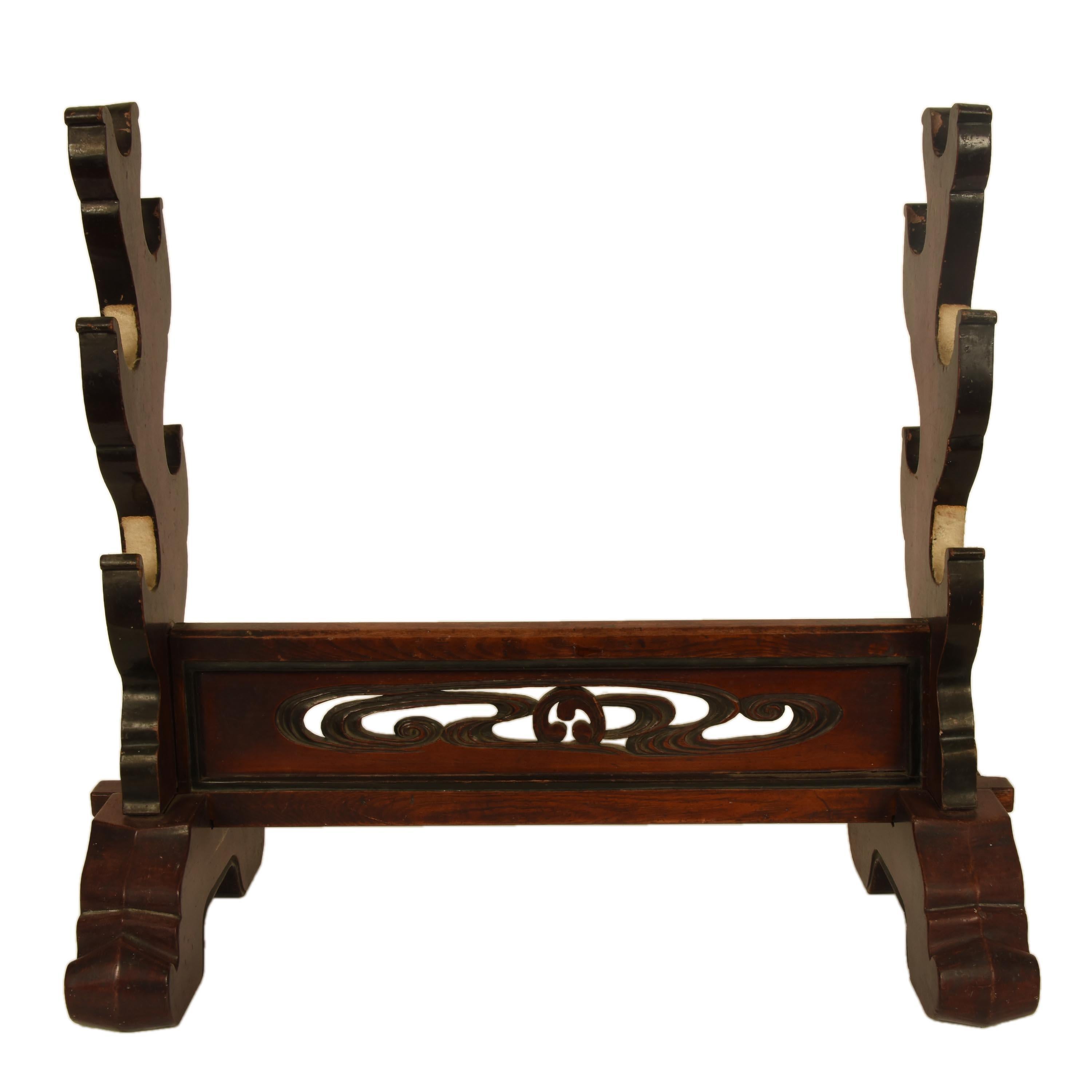 A rare, antique Japanese sword stand for the display of samurai swords. It has been decoratively hand carved from zelkova wood. Named keyaki in Japan, this wood is a highly prized hardwood used for furniture because of it's beautiful grain and
