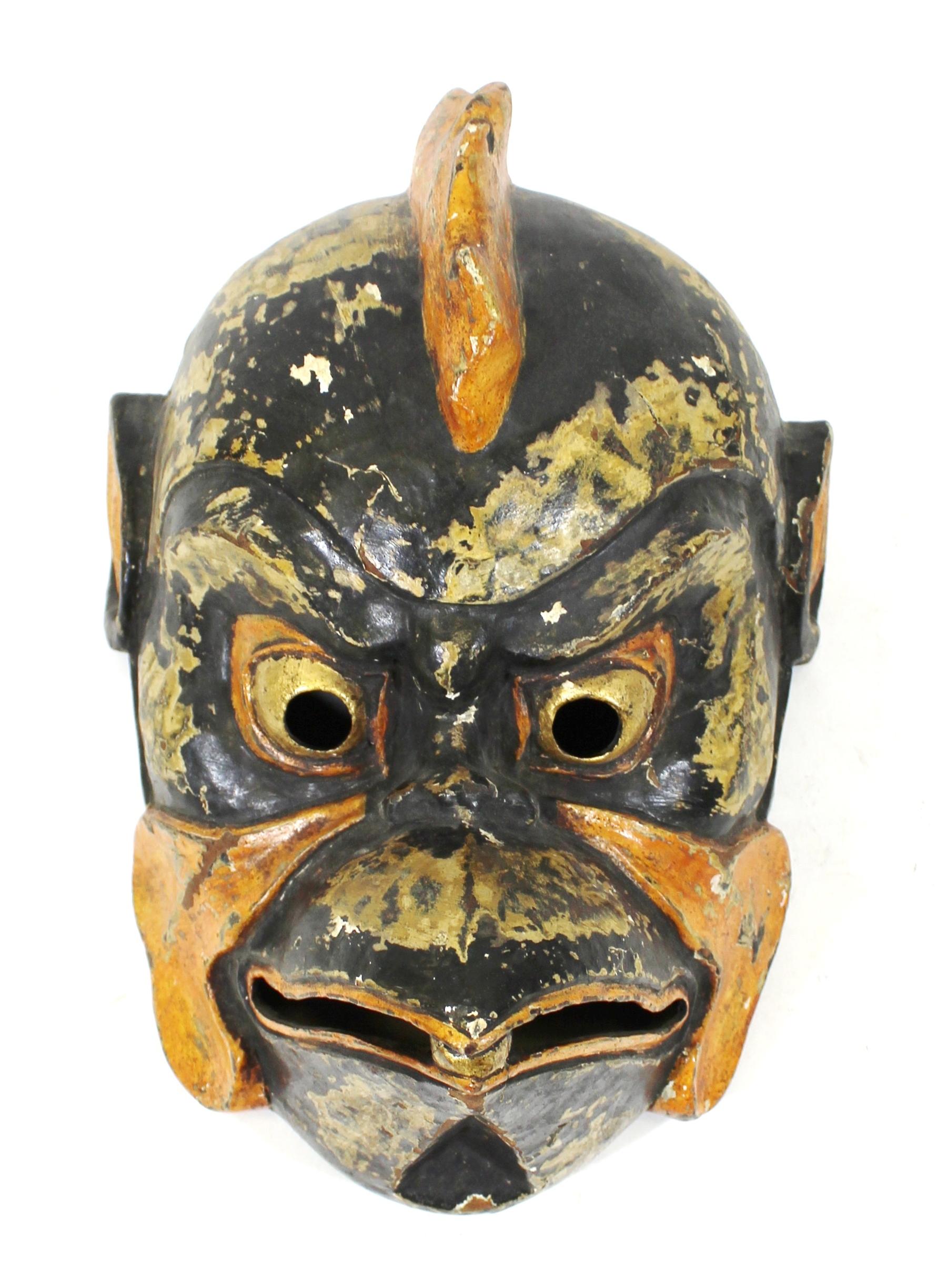 Japanese carved, painted and parcel gilt wood mask of Tengu, the Japanese human-bird hybrid folk religion character. Early 20th century, with old hand-written label glued to the inside.