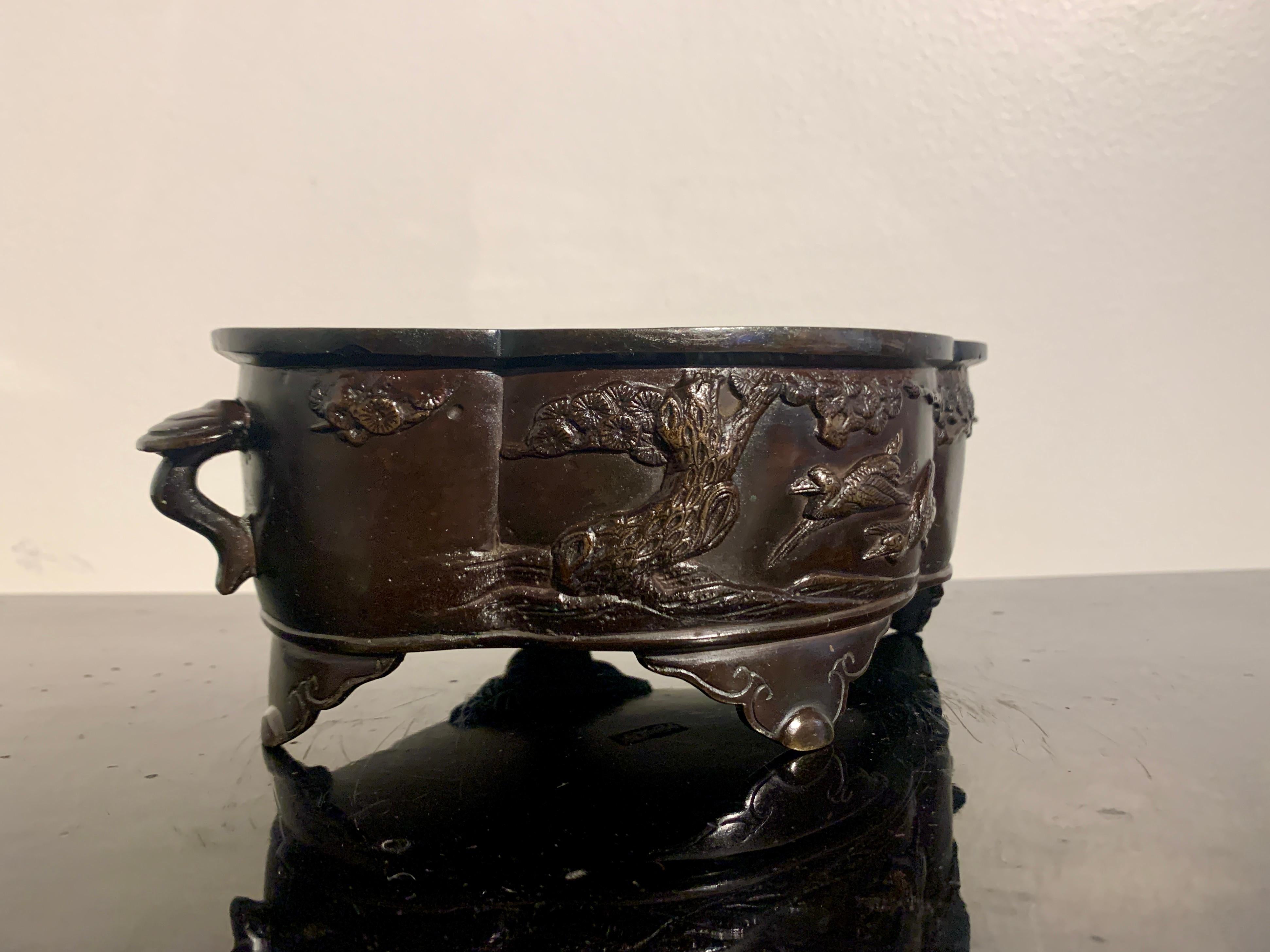 A lovely small Japanese cast bronze suiban, shallow vessel for ikebana flower arranging, signed Takashima, Meiji Period, circa 1900, Japan.

The small Japanese bronze suiban of lobed, quatrefoil form, with two handles, and set on four shaped feet.