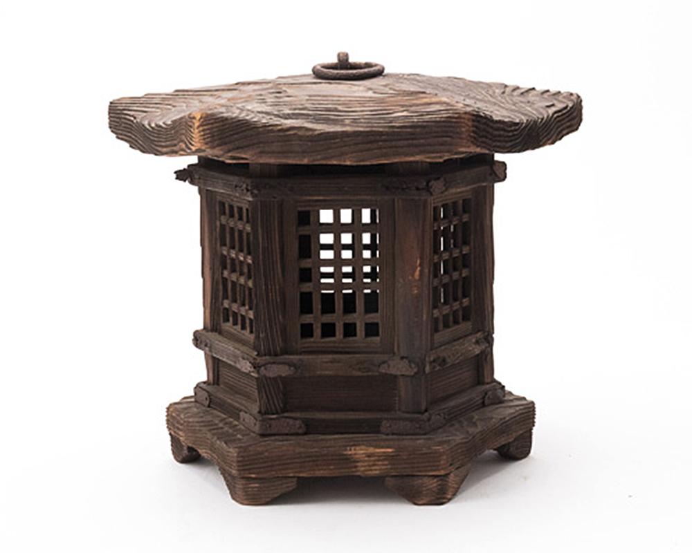 Japanese hexagonal shaped garden lantern made from cedar that has been weathered by wind and rain to produce the most wonderfully tactile wood grain patina that gives an appearance of a topographical map. It features wooden lattice windows and cast