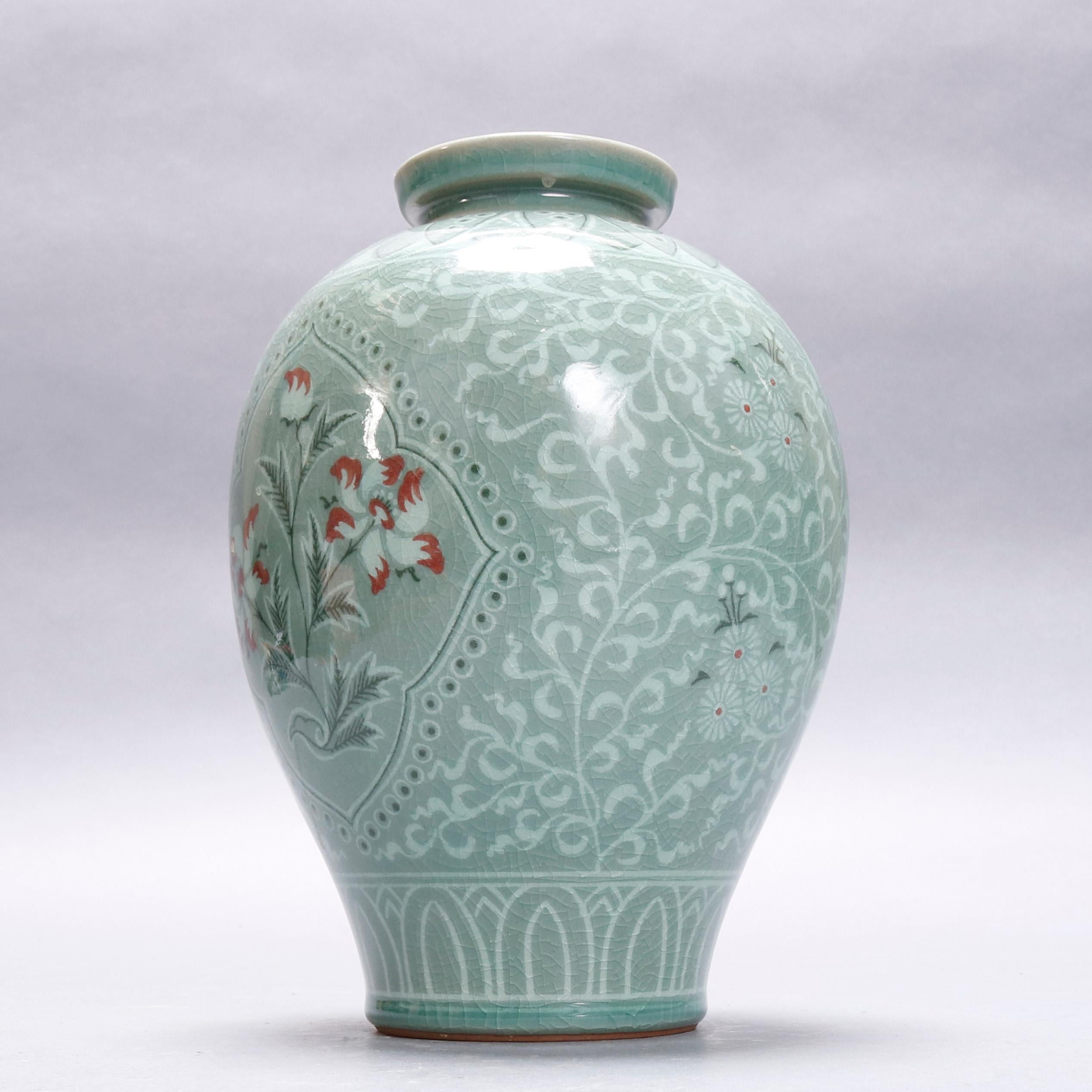 A Japanese bulbous porcelain vase offers jade green Celadon glazing with all-over scroll and foliate decoration having central floral reserve, repeating stylized leaf collar and base rim, chop mark signed on base, 20th century.

***DELIVERY NOTICE –