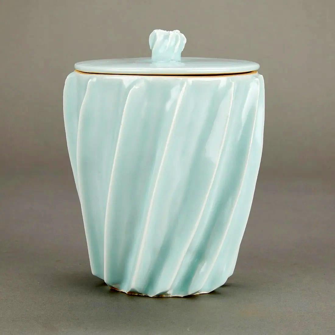 A ceramic lidded celadon vessel made by Japanese potter Uichi Shimizu (1926-2004) circa post 1980s. The vessel was known as Mizusashi in Japanese and used as a freshwater container to refill the Kama kettle during the Chado tea ceremony. Quite