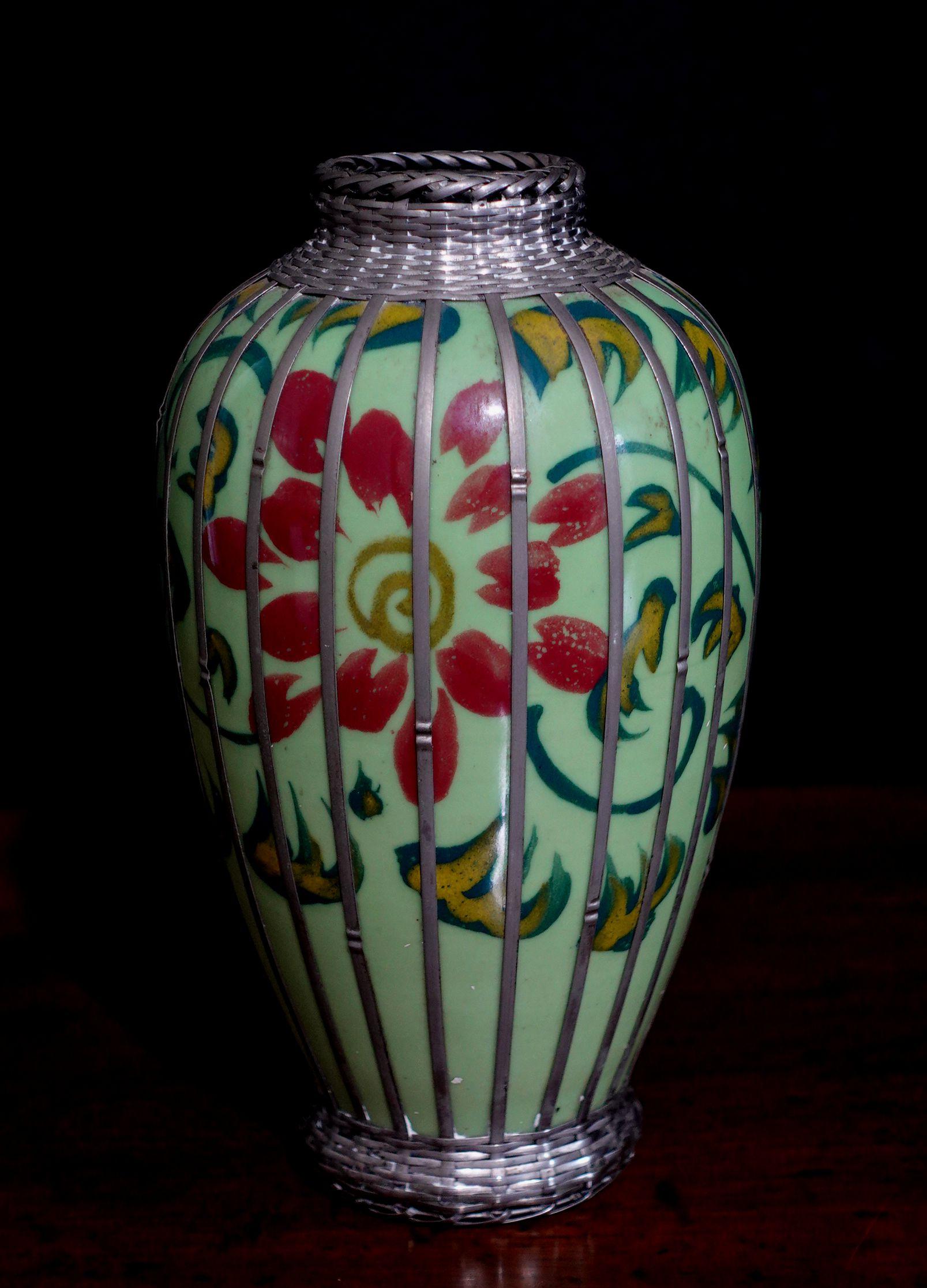 Vintage Japanese celadon glazed porcelain vase has a hand-painted floral design with basket weave silver overlay design. Measures approx. 6 1/8