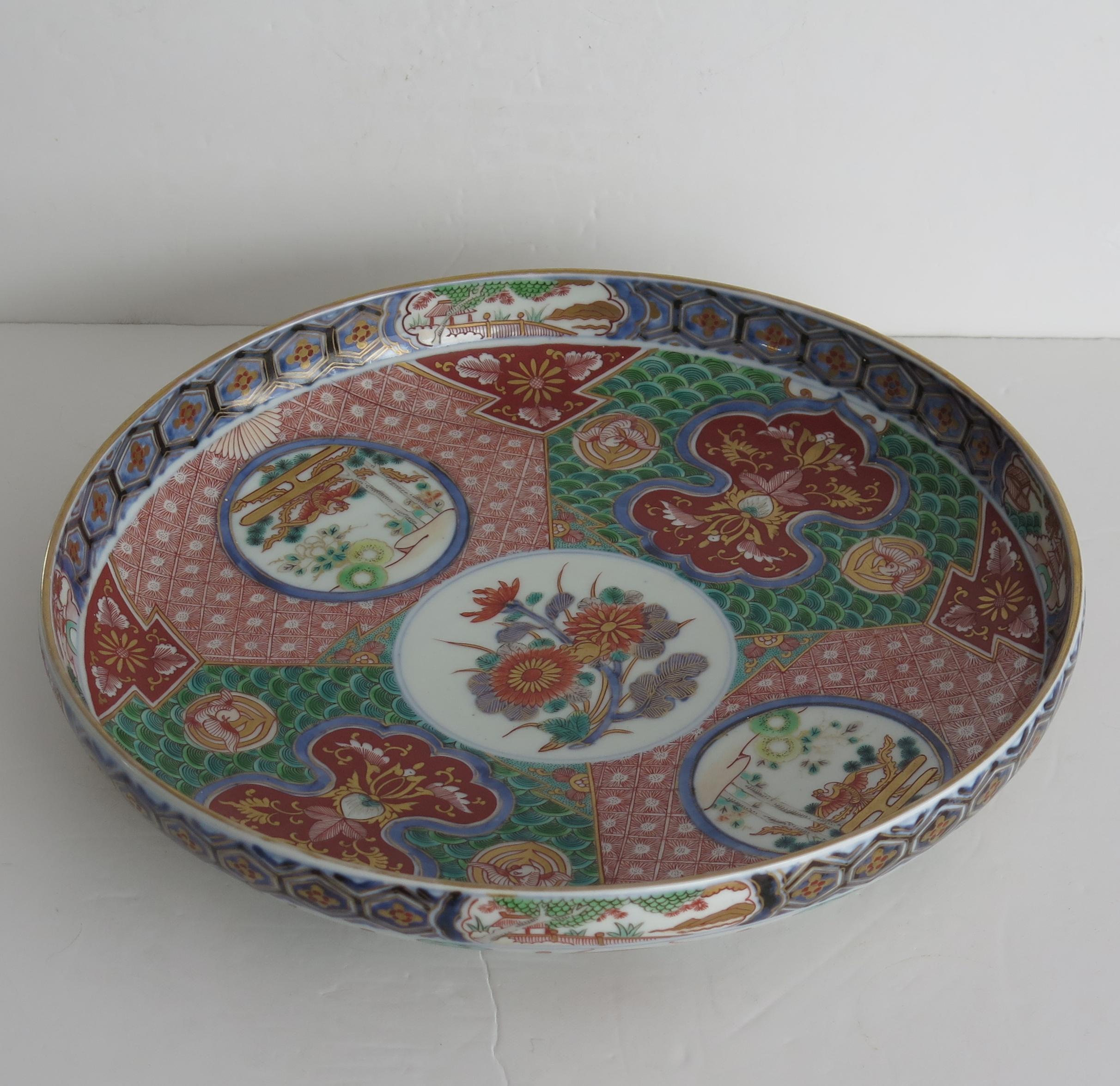 This is a very beautiful example of a Japanese, Arita- Imari porcelain ceramic large Dish or Plate with finely hand painted decoration, dating to the Edo period circa 1810.

This dish is very finely hand painted in great detail, decorated inside