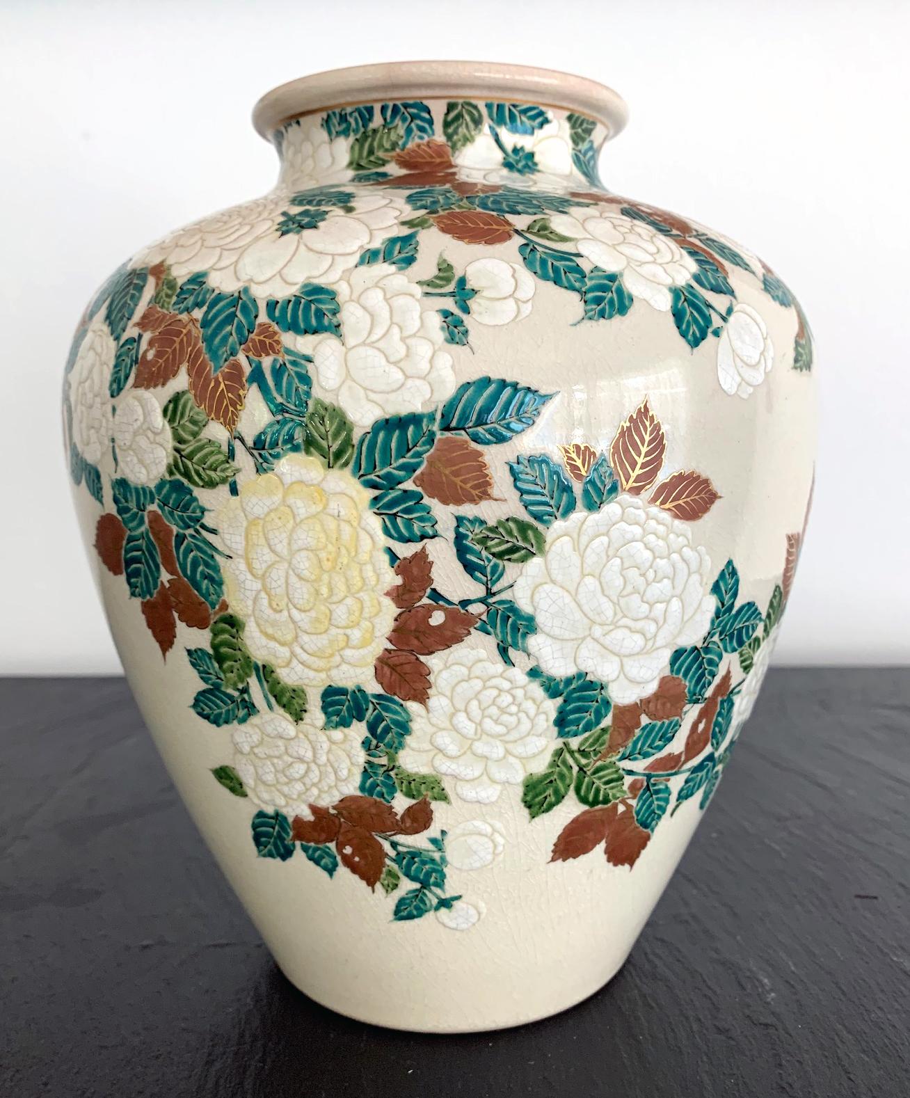 This stoneware vase of a jar form was finely decorated with low relief carving and delicate colored glazes depicting bundles of peony flowers. It was made by Ito Tozan I (1846-1920) circa 1890-1900s in the late Meiji Period. The color pallet was