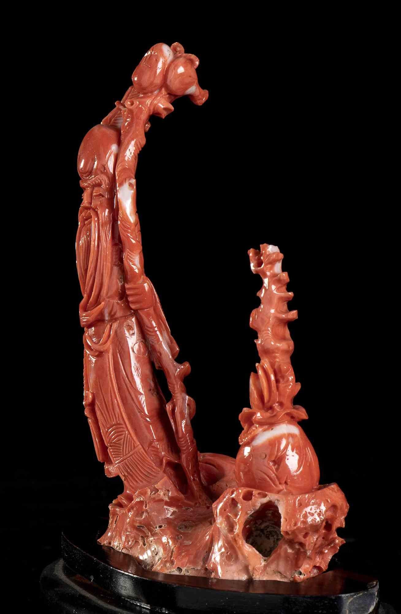 Cerasuolo coral carving (corallium elatius)

Coral carving depicting Shoulao, the God of Longevity, represented with his typical large cranium, the right hand holding a walking stick, a peach in the left hand as a symbol of long life. Wooden base.