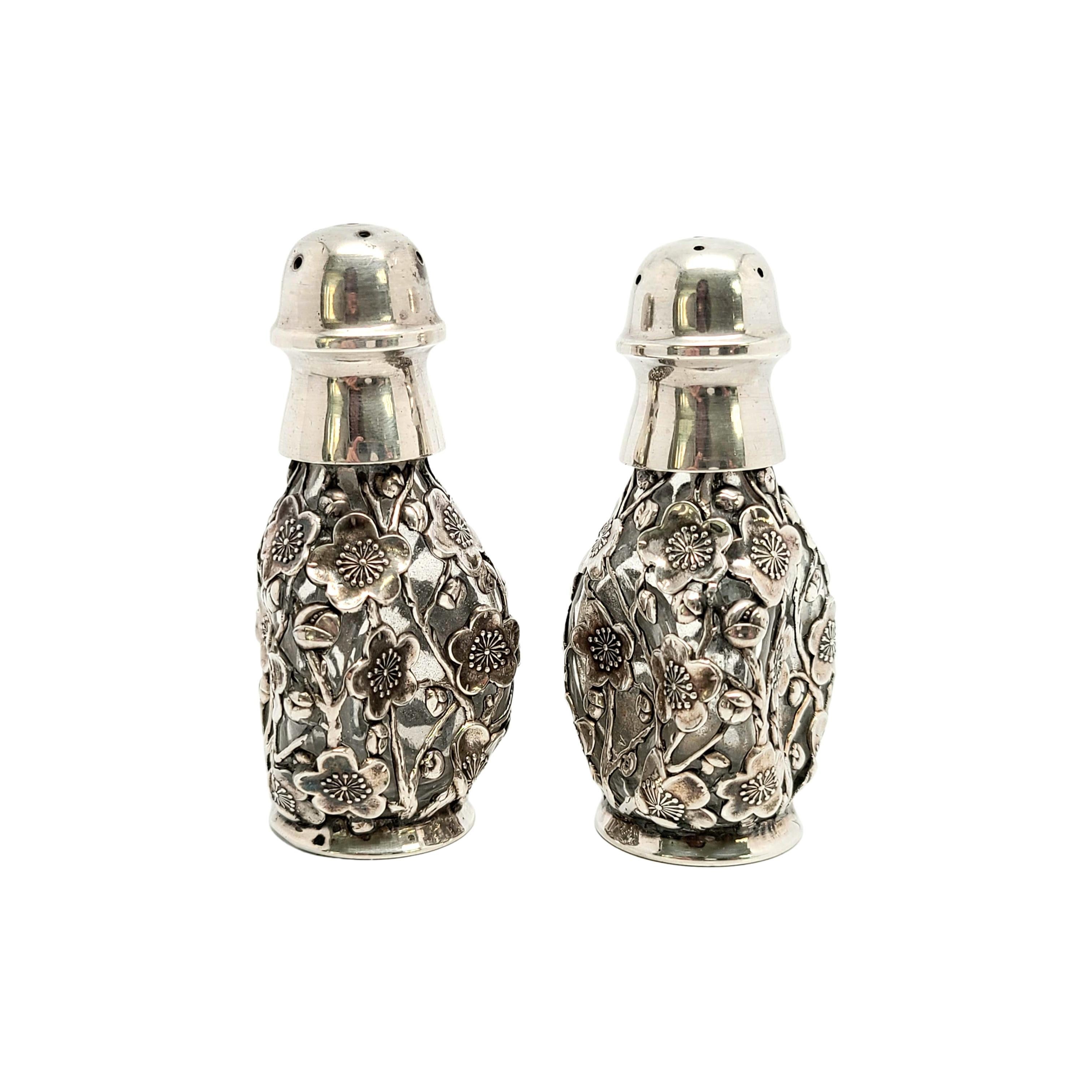 Vintage 950 sterling silver and glass salt and pepper shakers from Japan.

Pair of triangular shaped salt and pepper shakers with a 950 pure sterling silver cherry blossom design over glass.

Measures approx 3