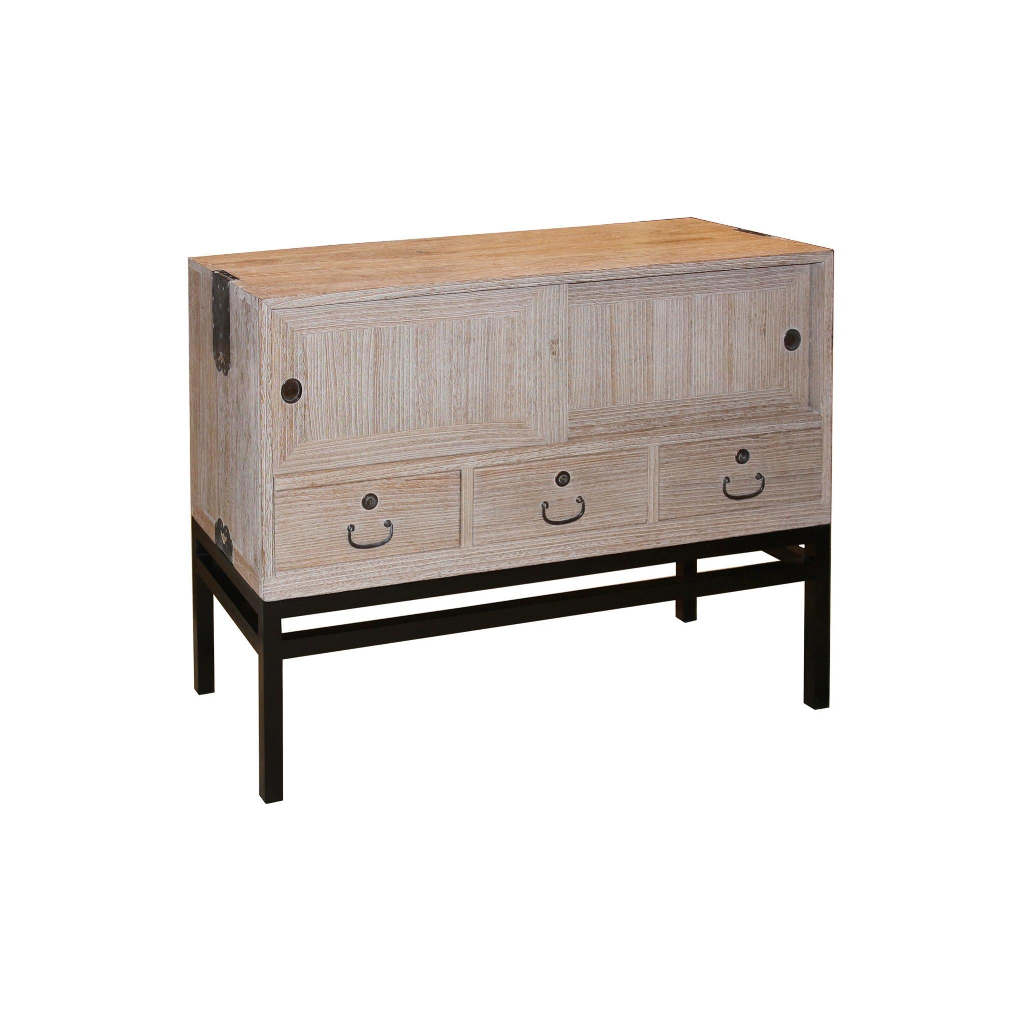 1920s Japanese tansu has been transformed by white wax for a contemporary look for a modern home. Original the top portion of a 3 section clothing chest with original copper hardware. Now on a custom made black lacquer wood stand. Use as a bedside