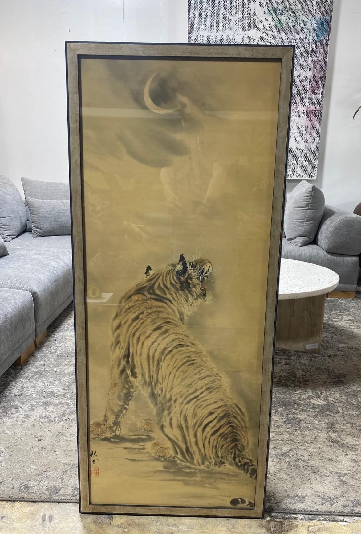 A beautiful and striking framed Asian tiger scroll painting featuring a regal tiger in the moonlight. This work is hand-painted with masterful brushstrokes on a silk/linen surface. We believe the work is Japanese but are not entirely sure as it
