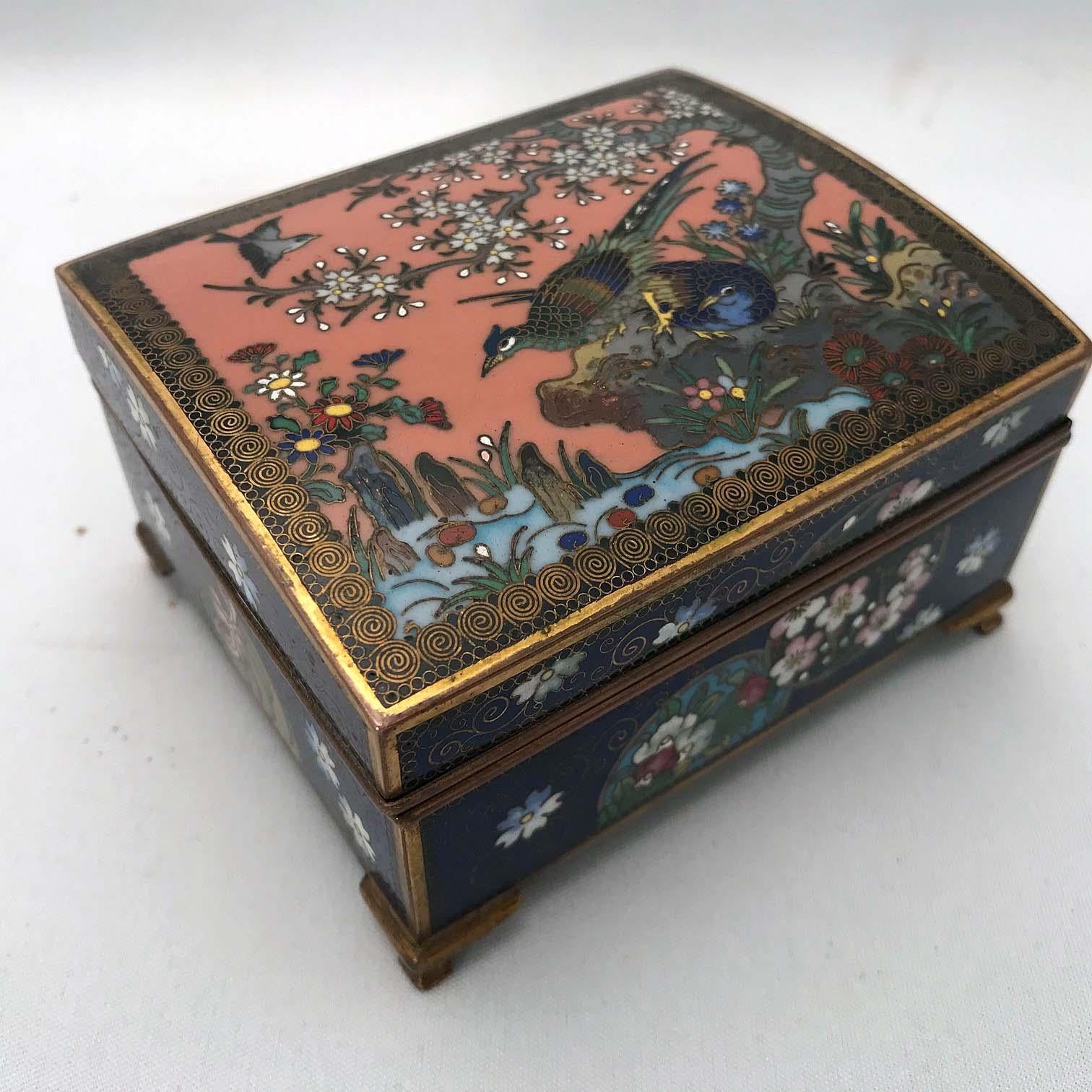 This box shows well the quality of early 20th century Japanese workmanship. The cover is finely worked with birds in a flowering and blossoming landscape. The birds are pheasants, the blossoms perhaps stylized prunus. The sides repeat the motif. The