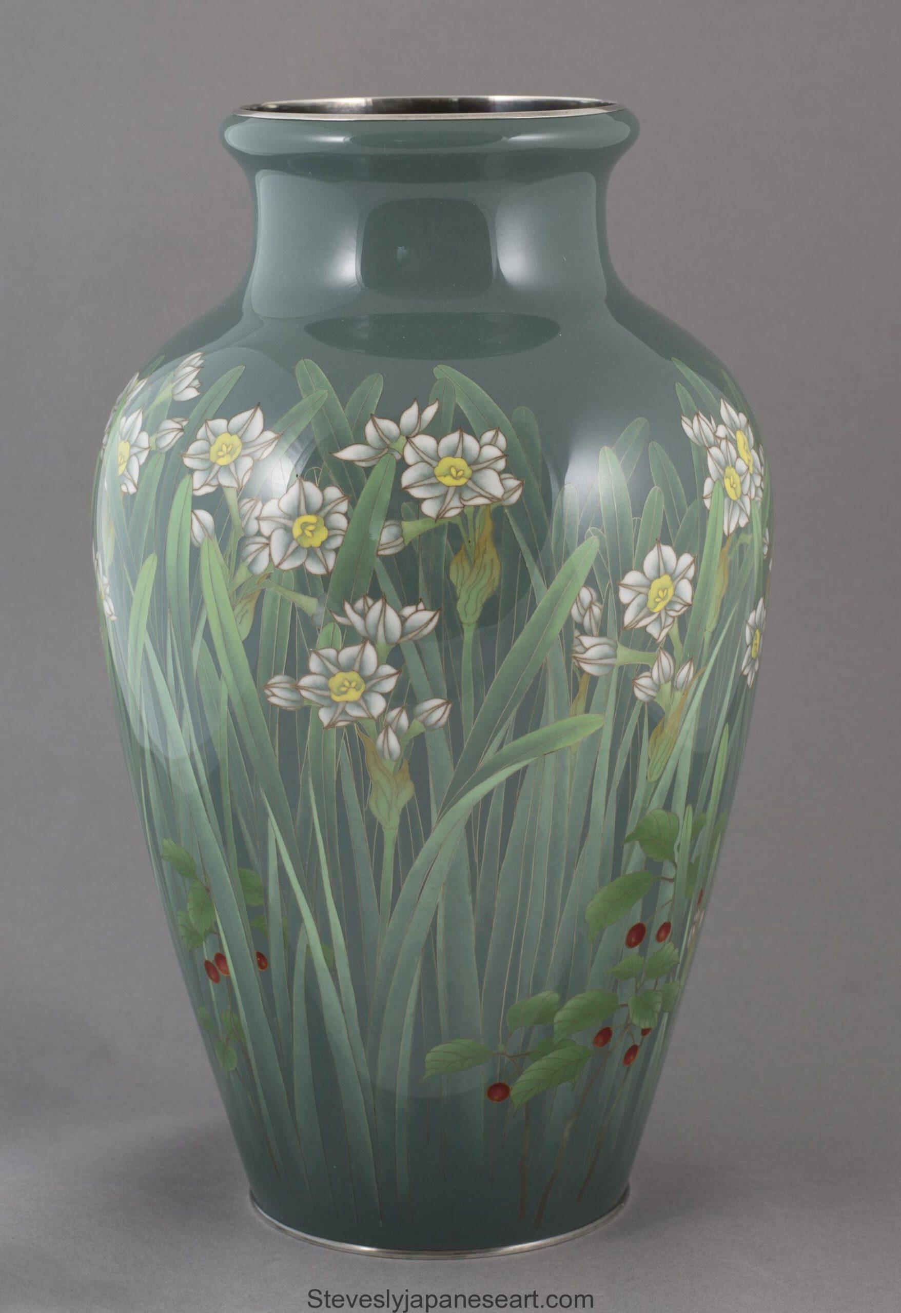 As part of our Japanese works of art collection we are delighted to offer this Japanese Meiji period (1869-1912) circa 1910, cloisonné enamel vase depicting narcissus flowers amidst Japanese red berry plants (probably Rubus Phoenicolasius) complete