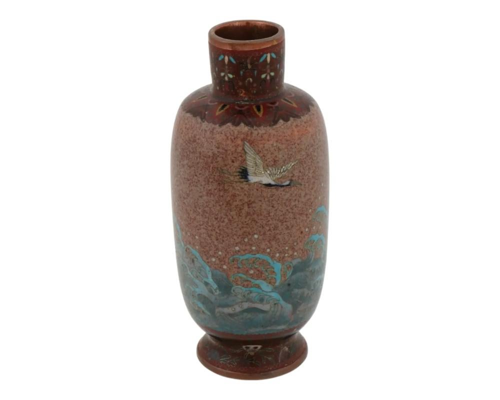 An antique Japanese early Meiji vase, most likely copper, decorated with cloisonne enamel and attributed to Honda Yasaburo, active circa 1870s - 1910. The elongated vase features a narrow neck, the exterior is decorated with polychrome cloisonne