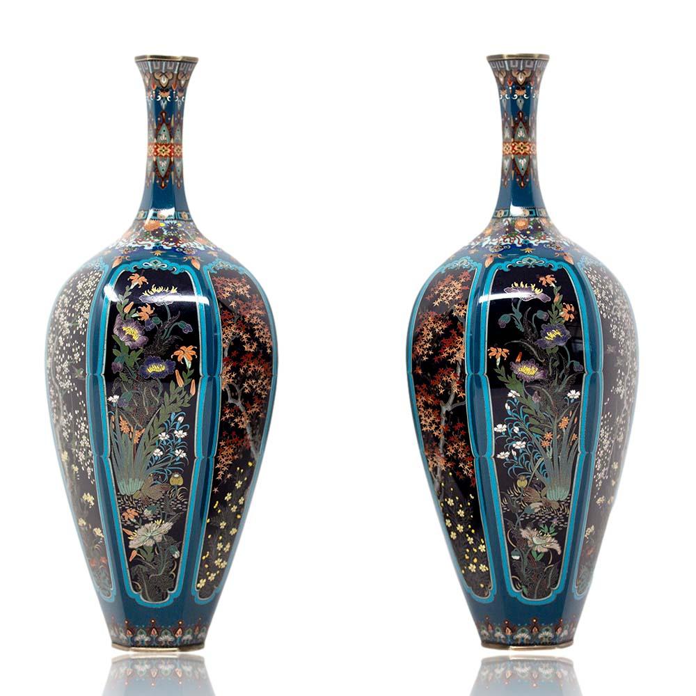 A sensational pair of Japanese Meiji period Cloisonne enamel bottle vases. The vases of slender hexagonal form with trumpet opening upon a circular foot. Decorated to the highest quality with tapered scenes depicting kacho-ga (flowers and birds)