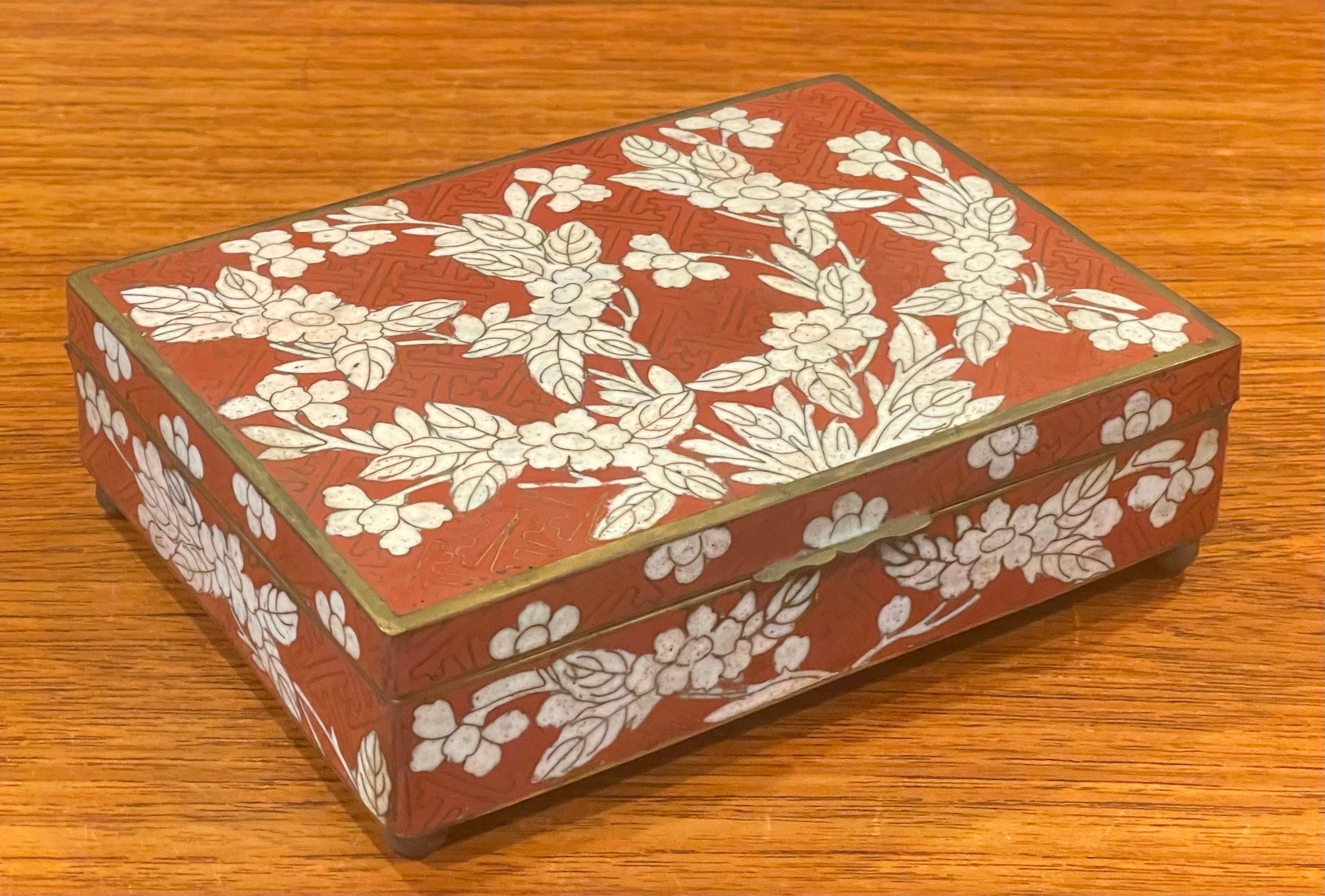 An very nice Japanese cloisonne lidded trinket box with brass bun feet, circa 1940s. The box has a great inticate floral design and is in very good vintage condition; it measures 6.125