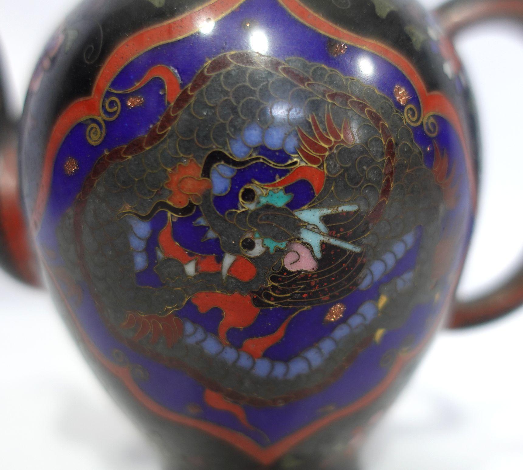 Quality work, amazing workmanship with absolutely fine details bronze cloisonné enameled teapot depicting the scene of a flying dragon with vivid colors of yellow, light golden green, red, blue, brown, and gold.
