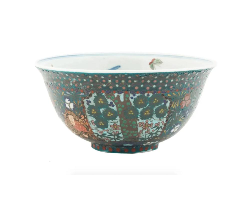 A fine and rare antique Japanese porcelain bowl from the Meiji period, 1868 to 1912. The surface is covered with a polychrome cloisonne enamel decor depicting a variety of interlocking floral and geometric designs. The interior is skillfully
