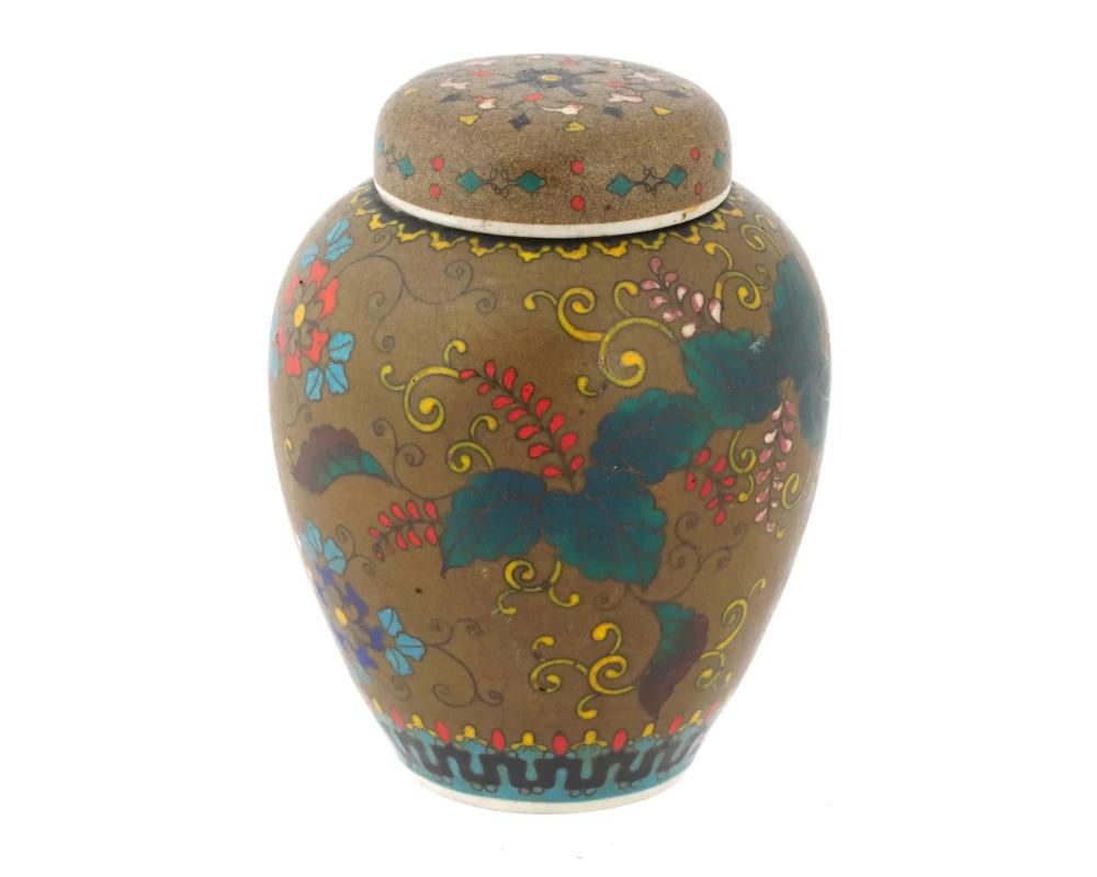 An antique Japanese late Meiji era covered Totai enamel on ceramic ginger jar. Circa: late 19th century .

The body and the lid of the ware are enameled with polychrome floral, foliate scroll, and foliage motifs made in the Cloisonne technique. The