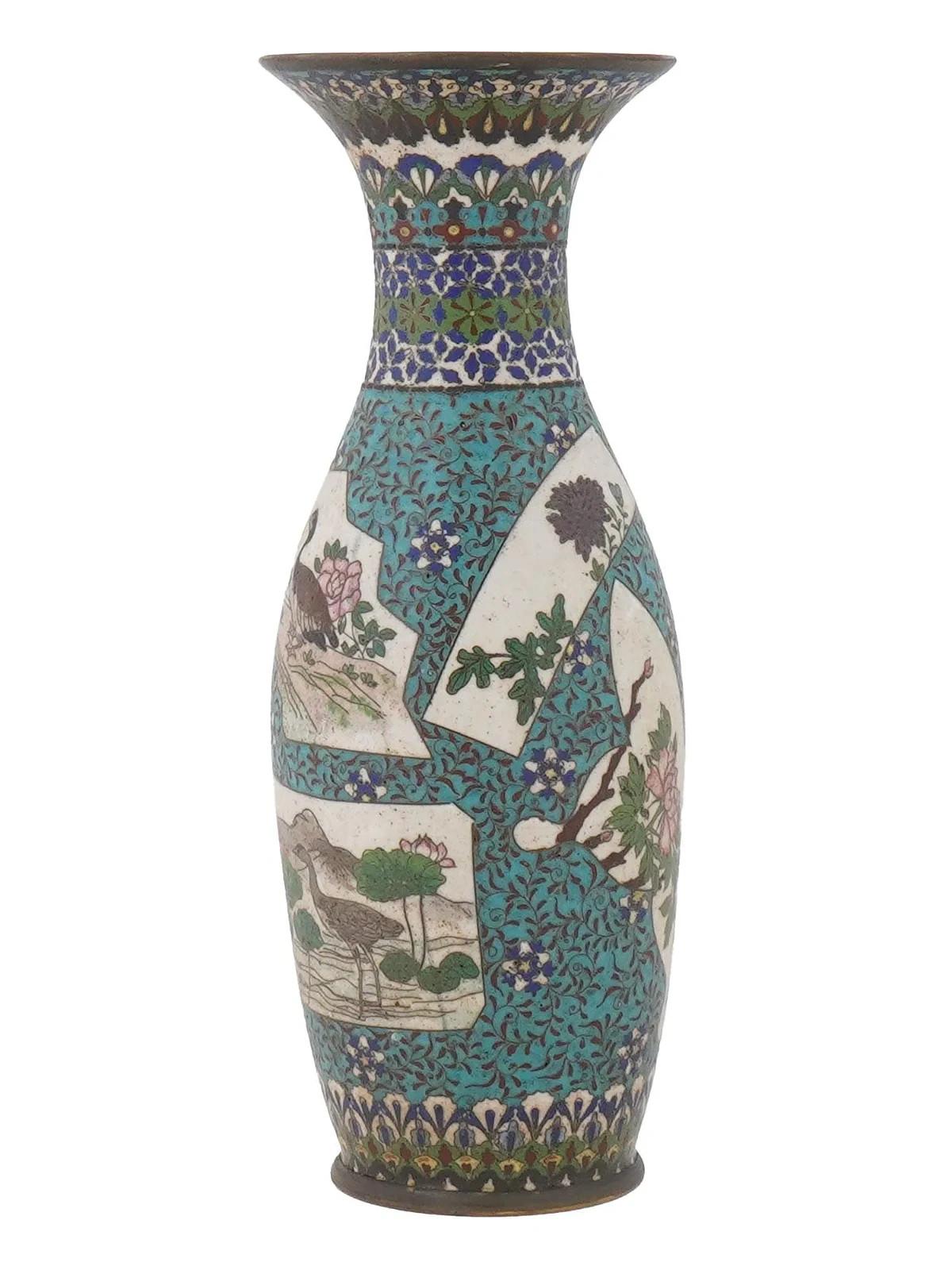 An antique Japanese cloisonne enameled vase with a slender, curved body and a flared neck. The vase is decorated with medallions depicting nature scenes, including birds perched among flowers and lotus plants, rendered in vibrant colors against a