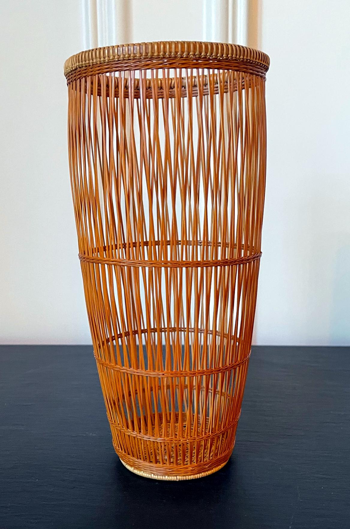 A Japanese Ikebana basket woven by bamboo artist Abe Motoshi (Japanese, b. 1942). Constructed with Madake bamboo and rattan with technique of open twinning and crossed variation of thousand-line, the basket features the Ayagake pattern, which are