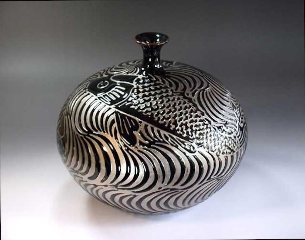 Japanese decorative porcelain vase, dramatically hand painted in platinum, set against a stunningly shaped porcelain body in black, a signed masterpiece belonging to the artist's signature fish collection by highly acclaimed master porcelain artist