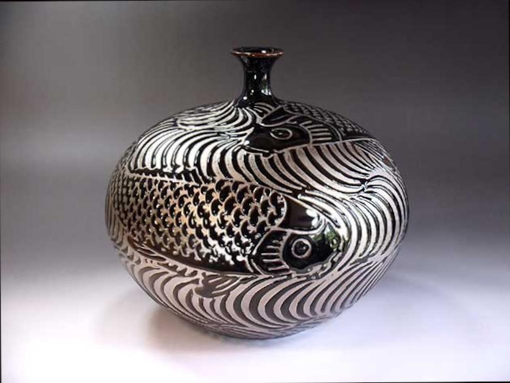 Unique Japanese contemporary decorative porcelain vase, intricately hand painted in platinum, set against a beautifully shaped body in black, a signed piece belonging to the artist's signature fish collection by highly acclaimed master porcelain