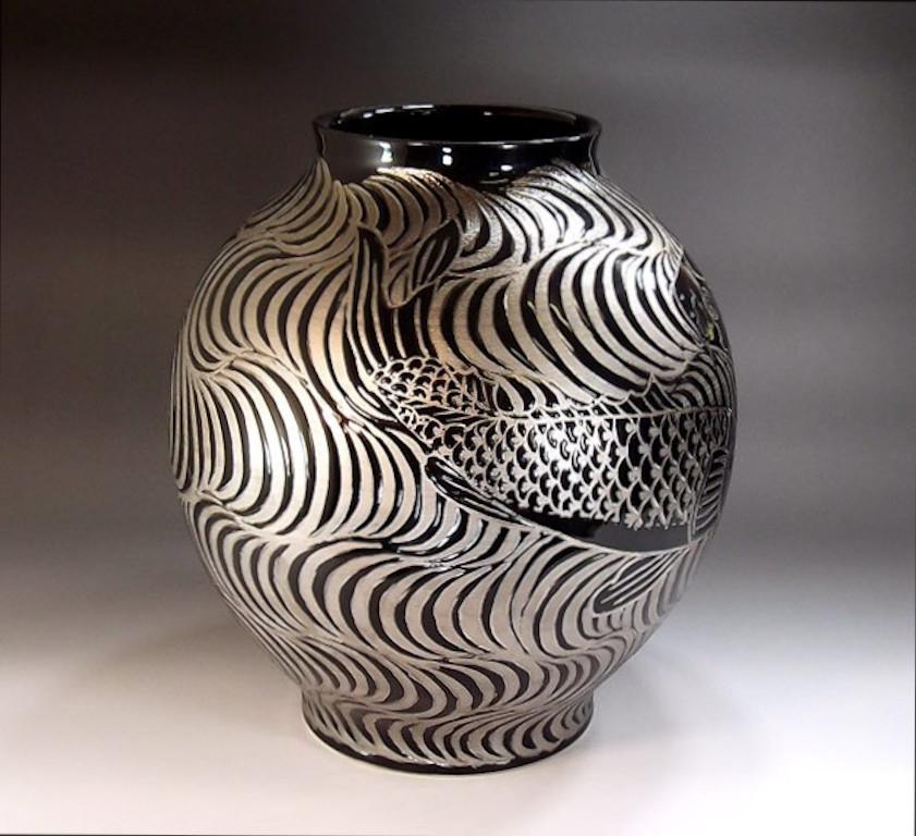 Exquisite Japanese contemporary decorative porcelain vase, dramatically hand painted in platinum, set against a stunningly shaped porcelain body in black, a signed masterpiece from the artist's signature fish collection by highly acclaimed master