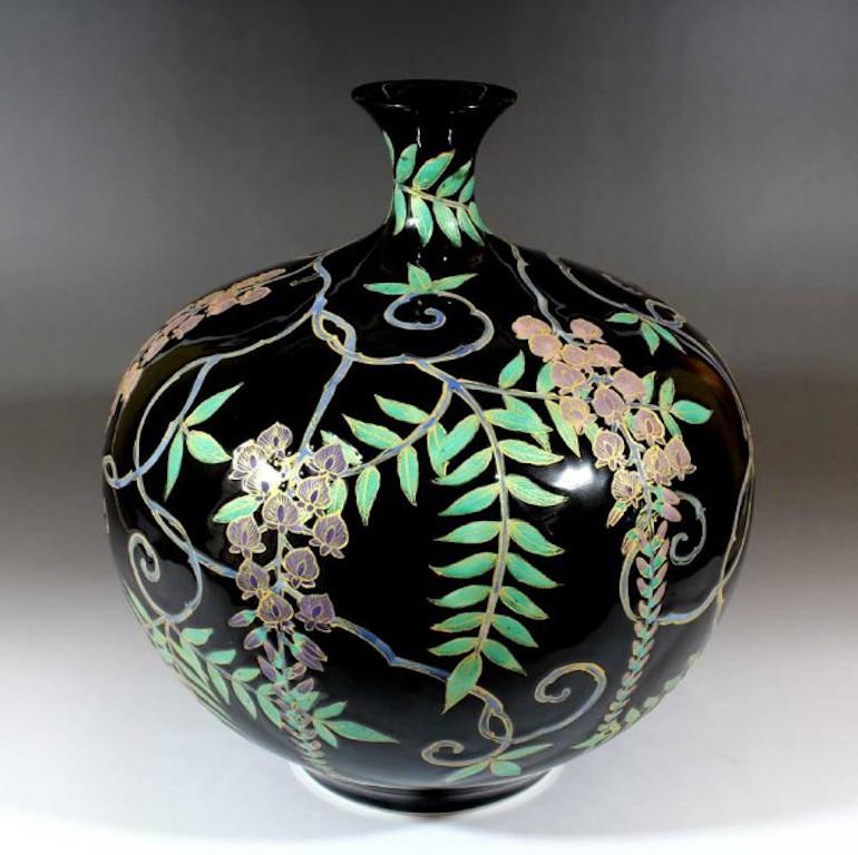 Japanese contemporary decorative porcelain vase, hand painted in black, green, purple and pink on a beautifully shaped body, a signed piece by highly acclaimed porcelain artist of Japan’s Imari-Arita region. The artist is the recipient of numerous