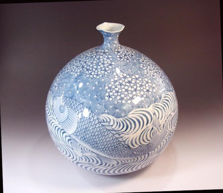Japanese contemporary decorative porcelain vase, dramatically hand painted in blue underglaze on a beautiully shaped ovoid porcelain bodyk, a signed piece belonging to the artist's signature fish collection by highly acclaimed master porcelain