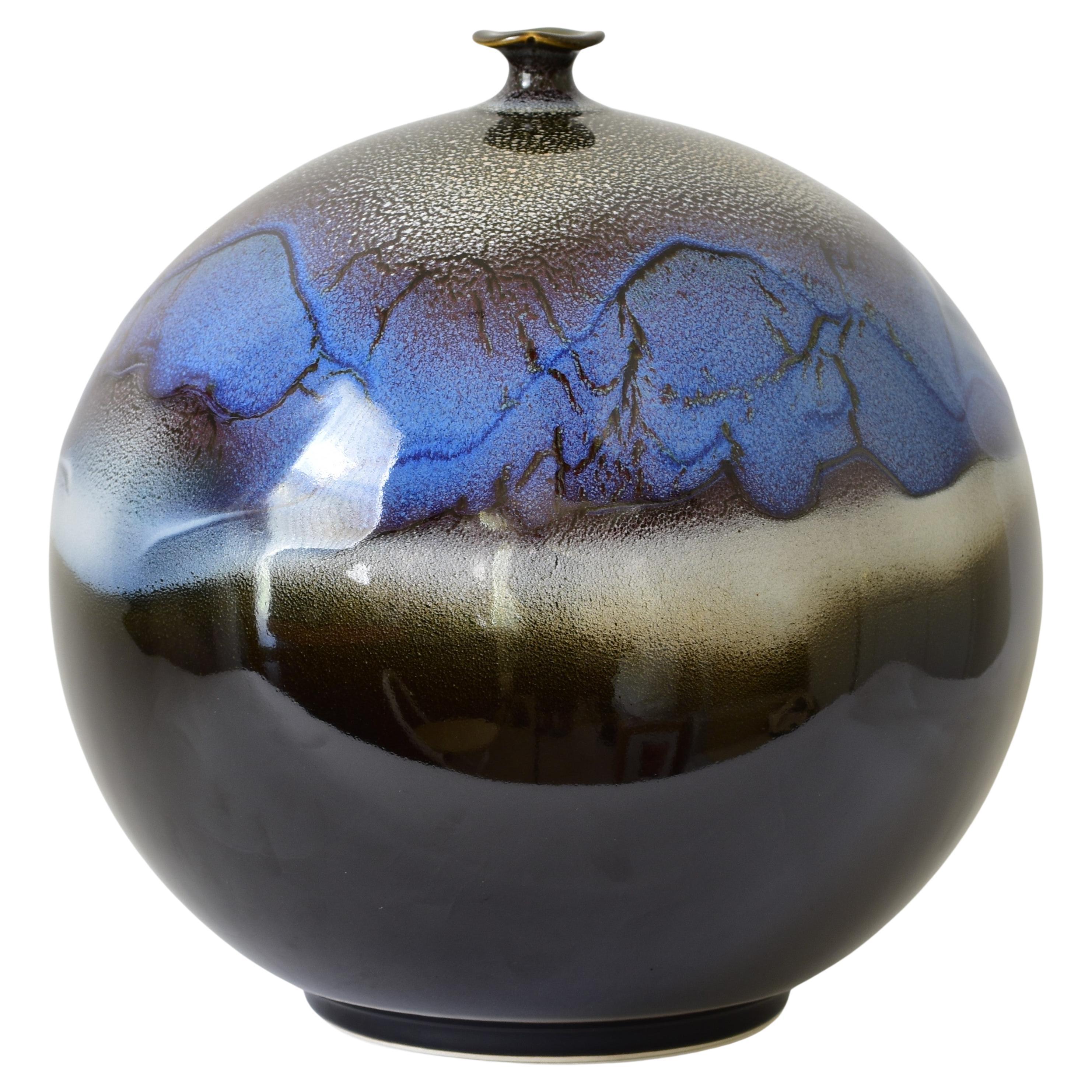 Exquisite museum quality Japanese contemporary hand-glazed decorative porcelain vase in a striking globular shape in blue and black, a mesmerizing masterpiece by highly acclaimed award-winning master artist of the Arita-Imari region of Japan. This
