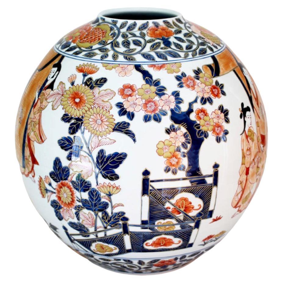 Contemporary Japanese decorative porcelain vase, hand painted on a beautifully shaped porcelain body in blue, pink and red with generous gold details, a signed masterpiece by highly acclaimed master porcelain artist of the Imari-Arita region of