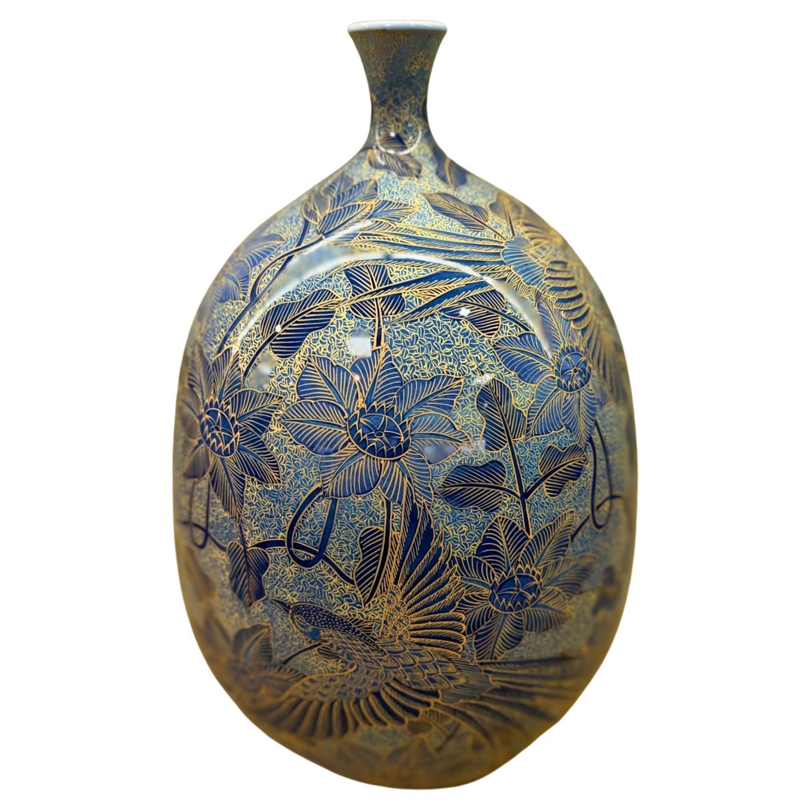 Extraordinary contemporary Japanese decorative porcelain vase, hand painted on a elegantly shaped porcelain body in blue, with extremely intricate patterns and extensive use of high purity gold, creating a mesmerizing palette with layers of