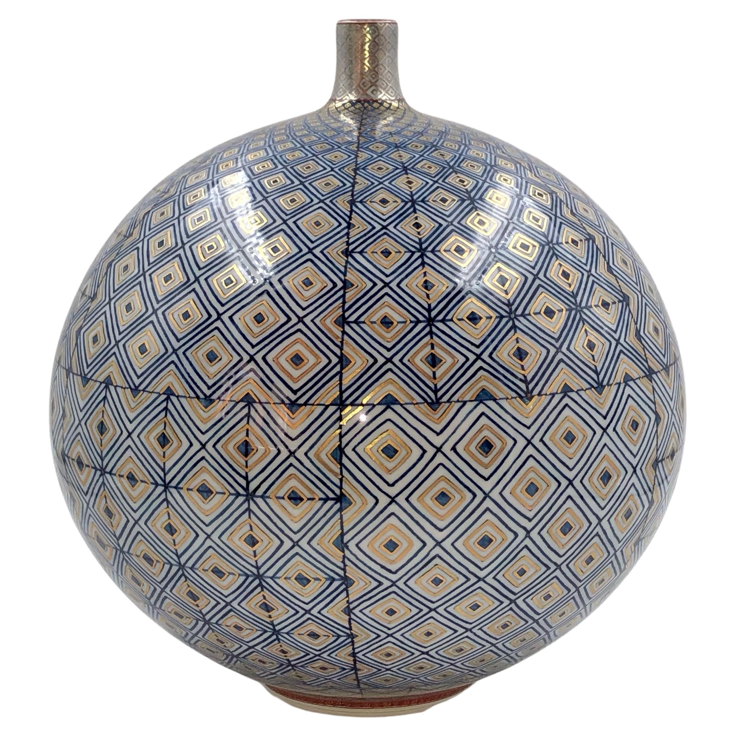 Exquisite Japanese contemporary museum-quality decorative porcelain vase, abreathtaking piece in a stunning ovoid shape featuring the artist's signature geometric pattern, extremely intricately hand painted in stunning midnight blue and gold. It is