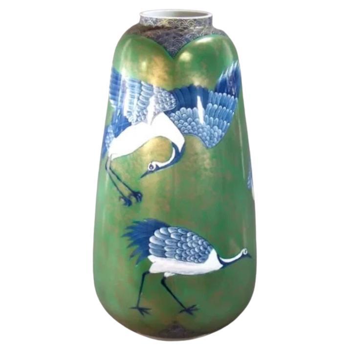 Exceptional tall Japanese contemporary decorative porcelain vase, hand painted in green and blue underglaze on a beautifully shaped body, a signed masterpiece by widely acclaimed master porcelain artist from the Imari-Arita region of Japan. This