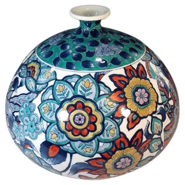 Contemporary Japanese decorative porcelain vase,  hand-painted in cobalt blue, yellow and green on a stunning ovoid shaped body, a signed piece by highly acclaimed master porcelain artist from the historic Imari-Arita region of Japan and recipient